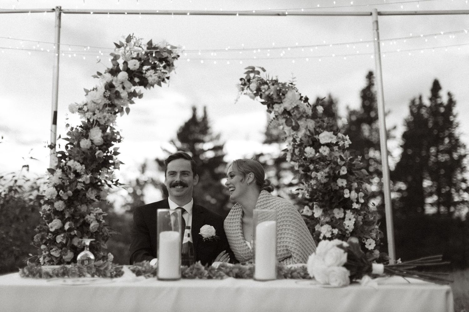 Bride and groom at head table laughing