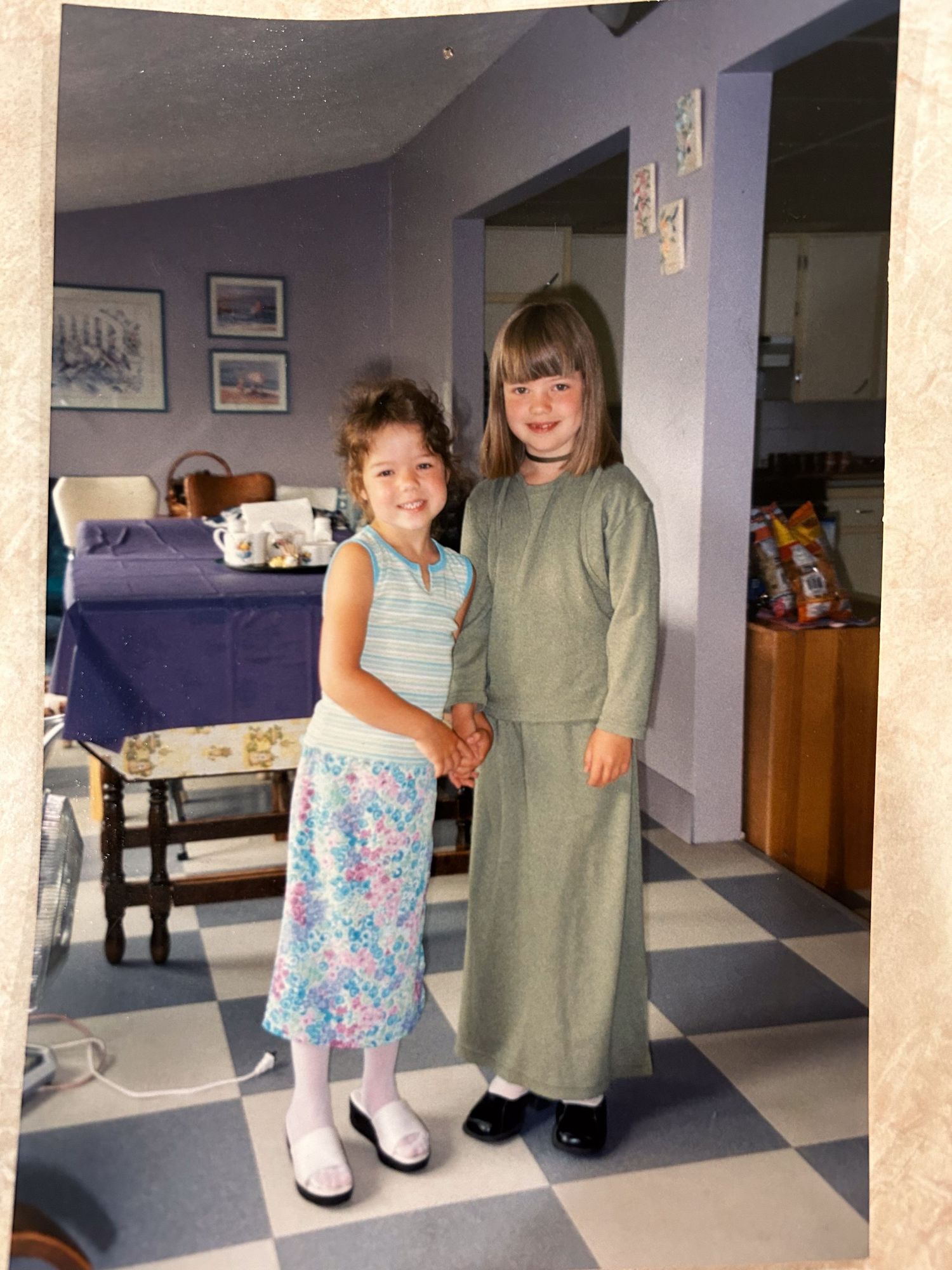 Interior scene showing children in matching outfits standing in a basement room.