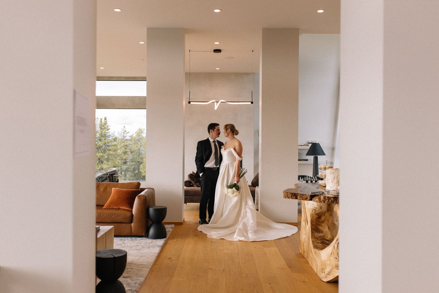 bride and groom looking at each other in hallway