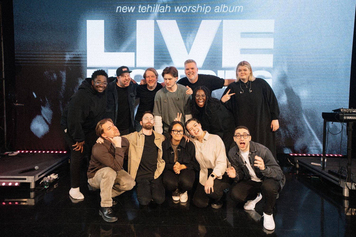 Banner promoting a new worship album with dark blue lighting and silhouettes.