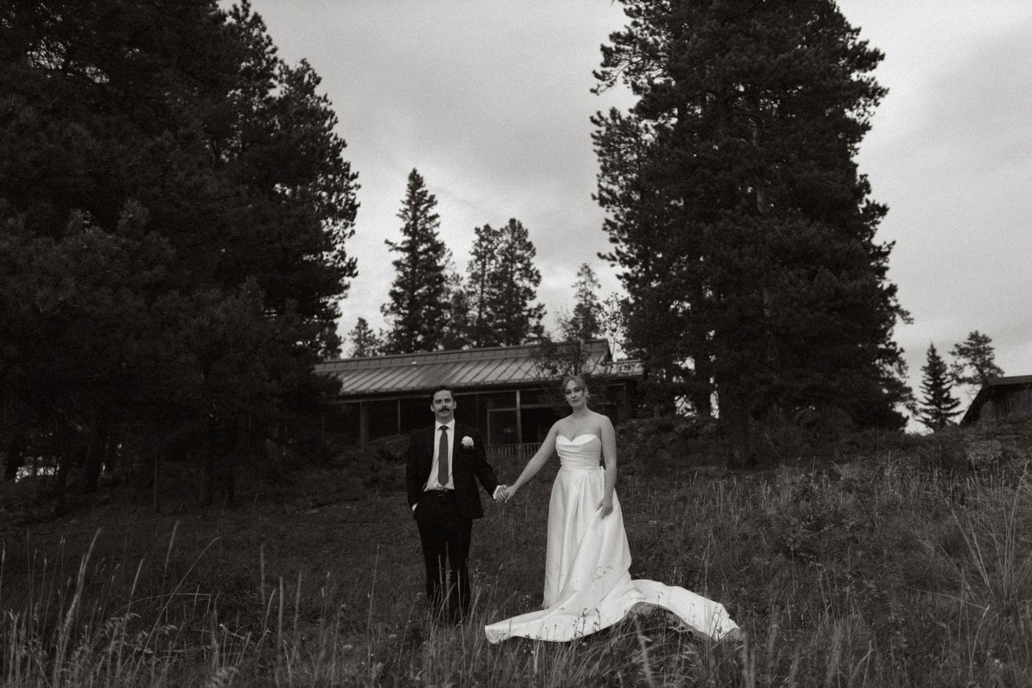 bride and groom holding hands, posing for portrait