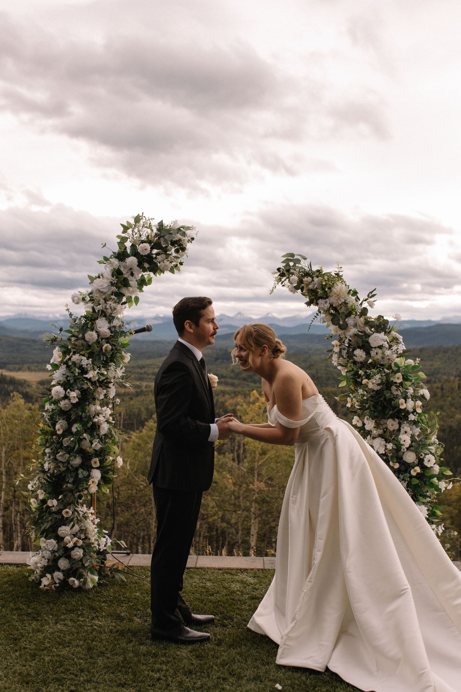 Bride and groom laughing at the altar