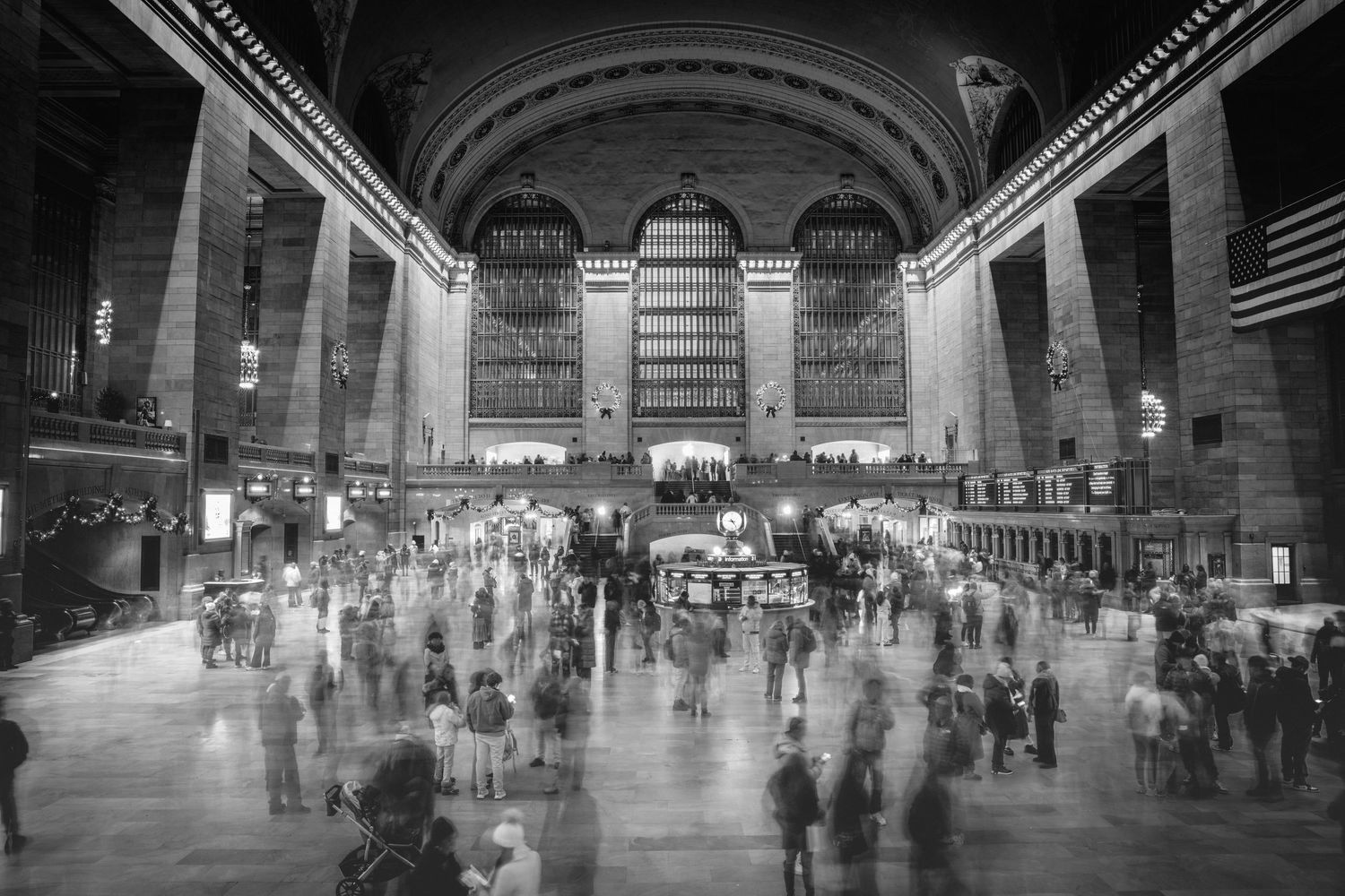 Black and white panoramic sequence showing Grand Central Terminal's bustling main concourse at different times of day.