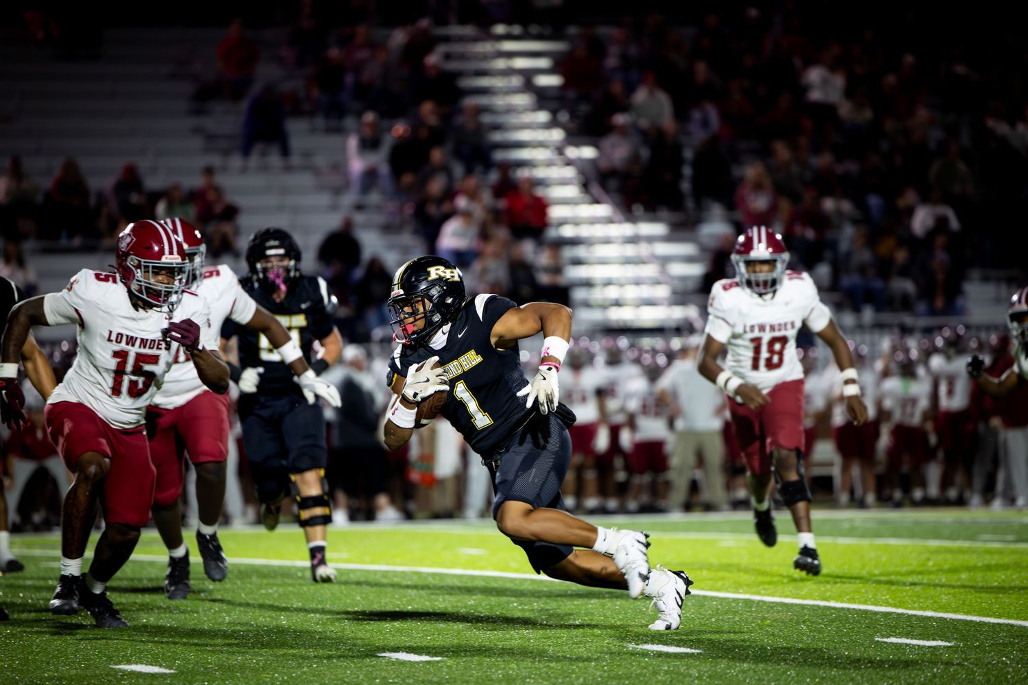 A series of action shots from a football game showing players engaged in tackles and plays on the field at night.