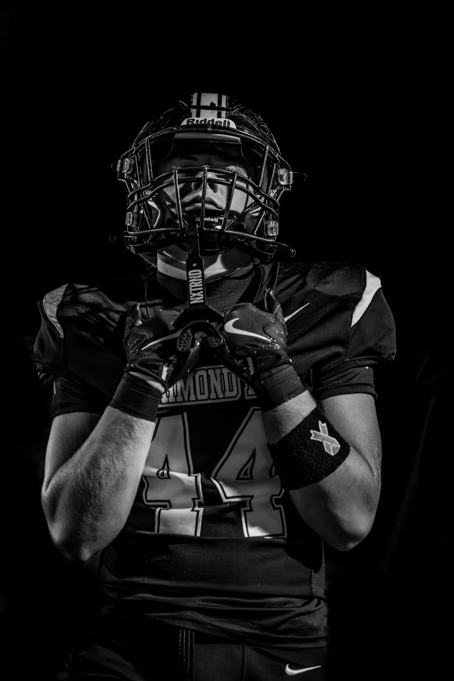 Dramatic black and white photo series of baseball catcher's protective gear and uniform details in dark lighting.