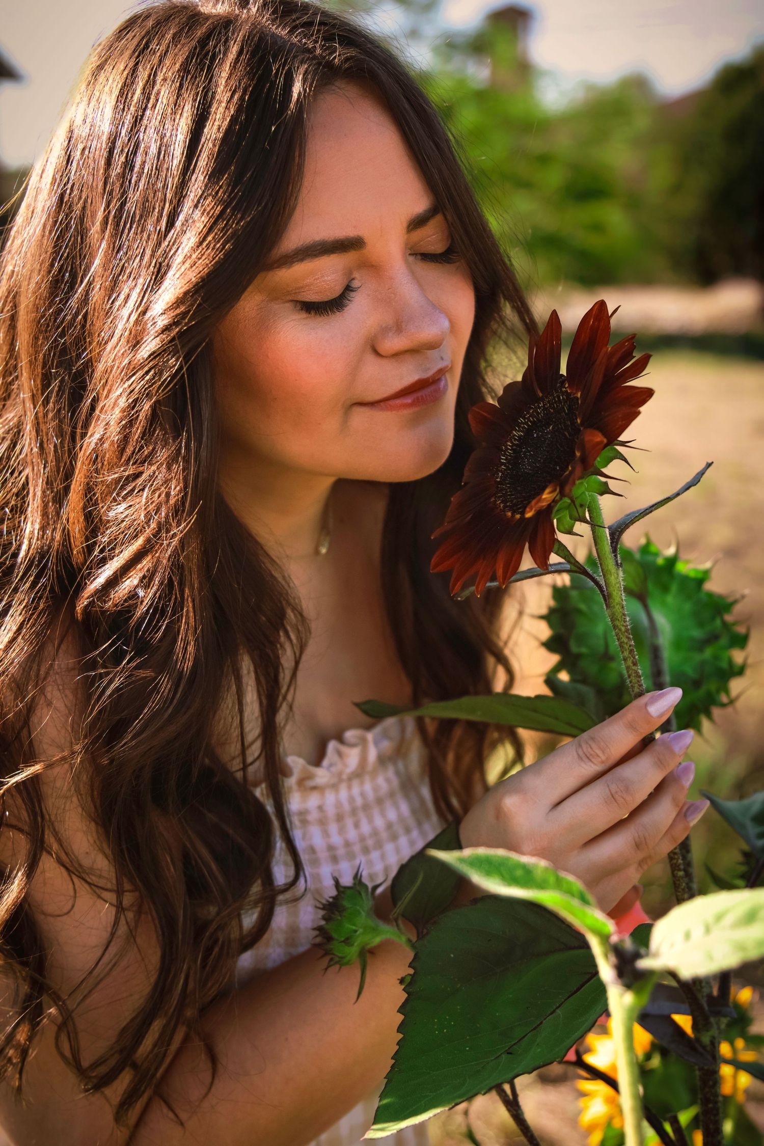 Close-up portrait of a young woman holding a flower during a Colorado flower farm photography session.