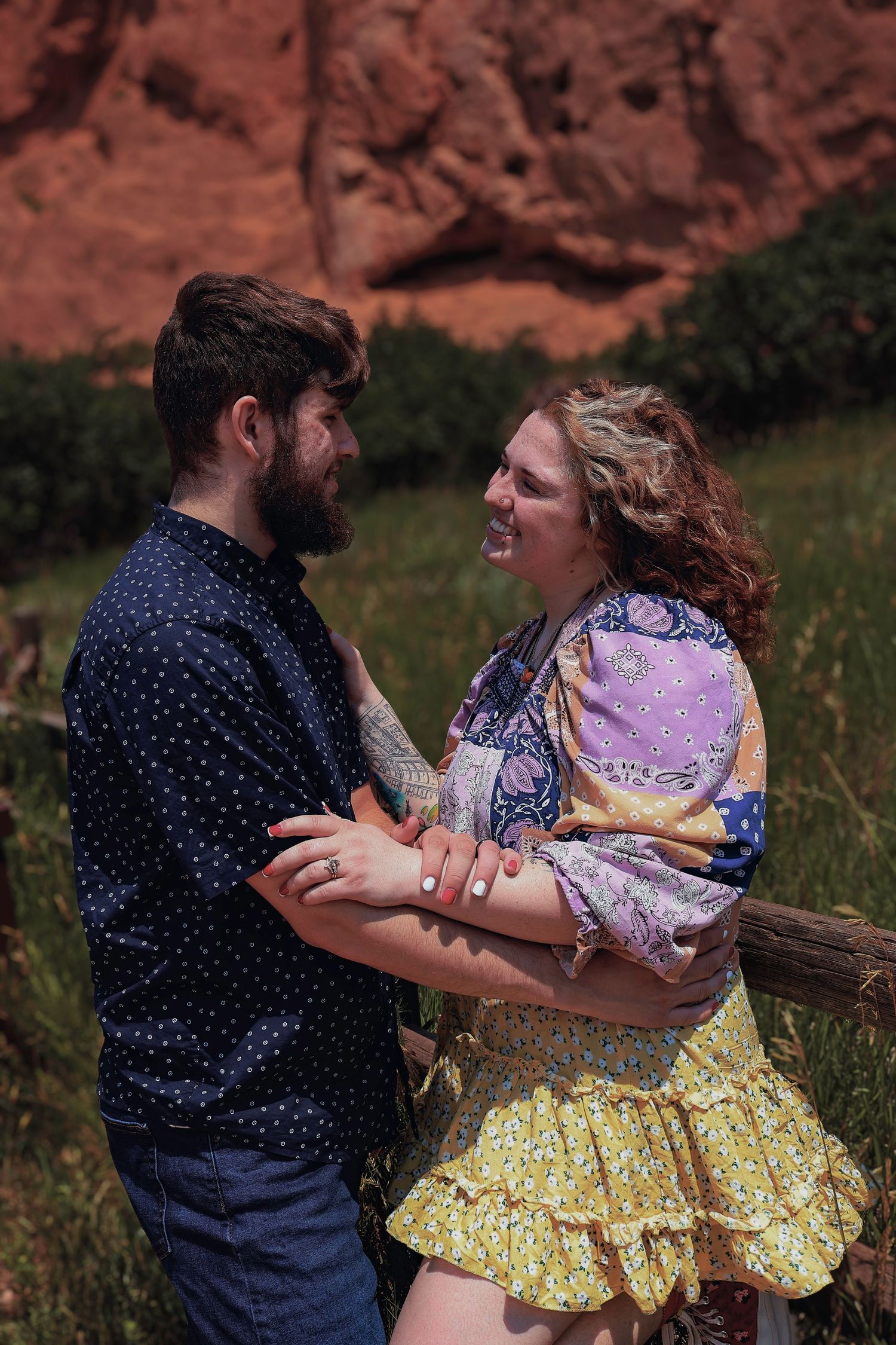 Couple smiling and embracing during an outdoor couples photography session at Garden of the Gods in Colorado Springs, Colorado.