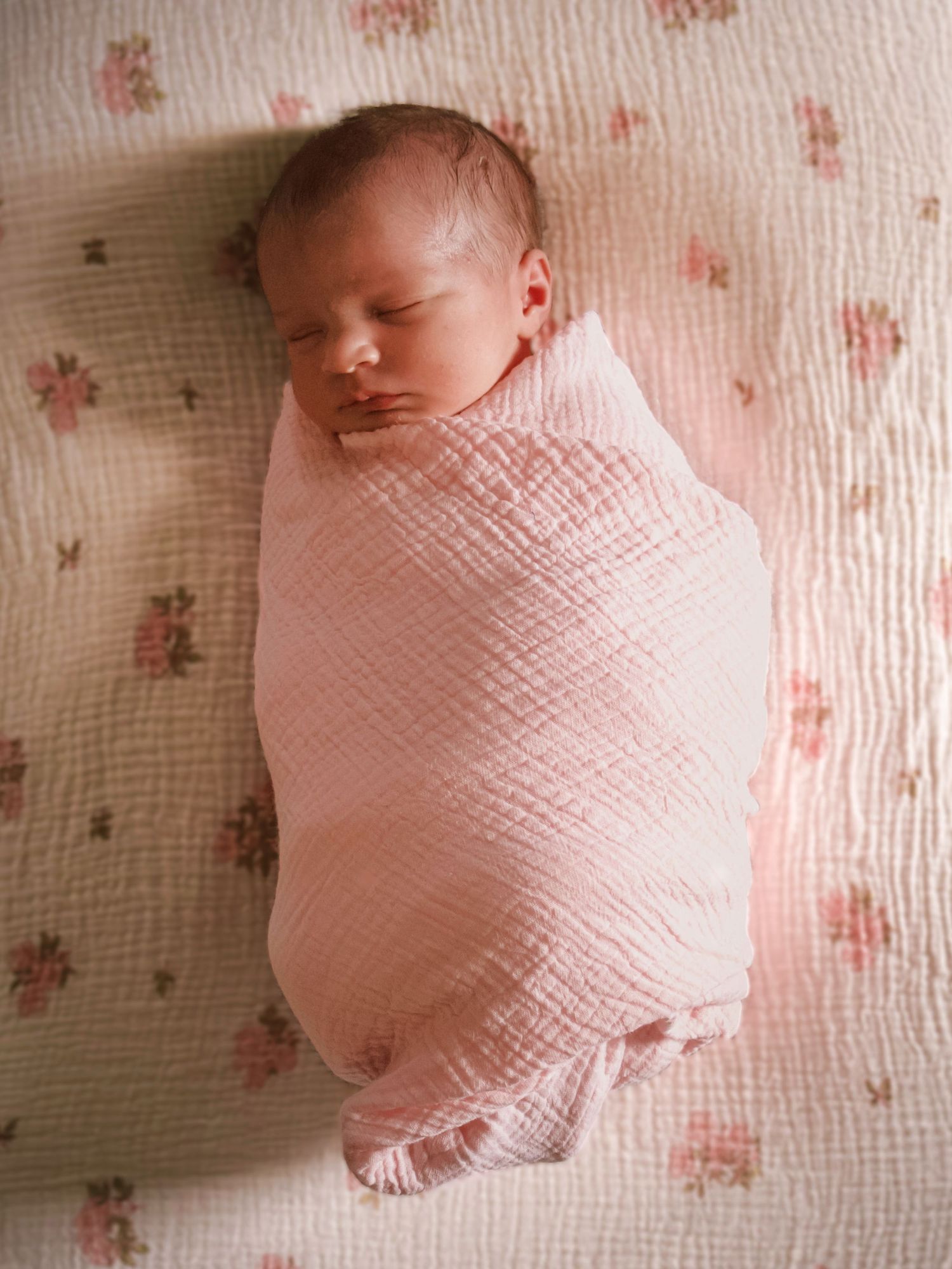 Newborn baby peacefully swaddled and resting during a lifestyle newborn photography session at home in Colorado Springs.