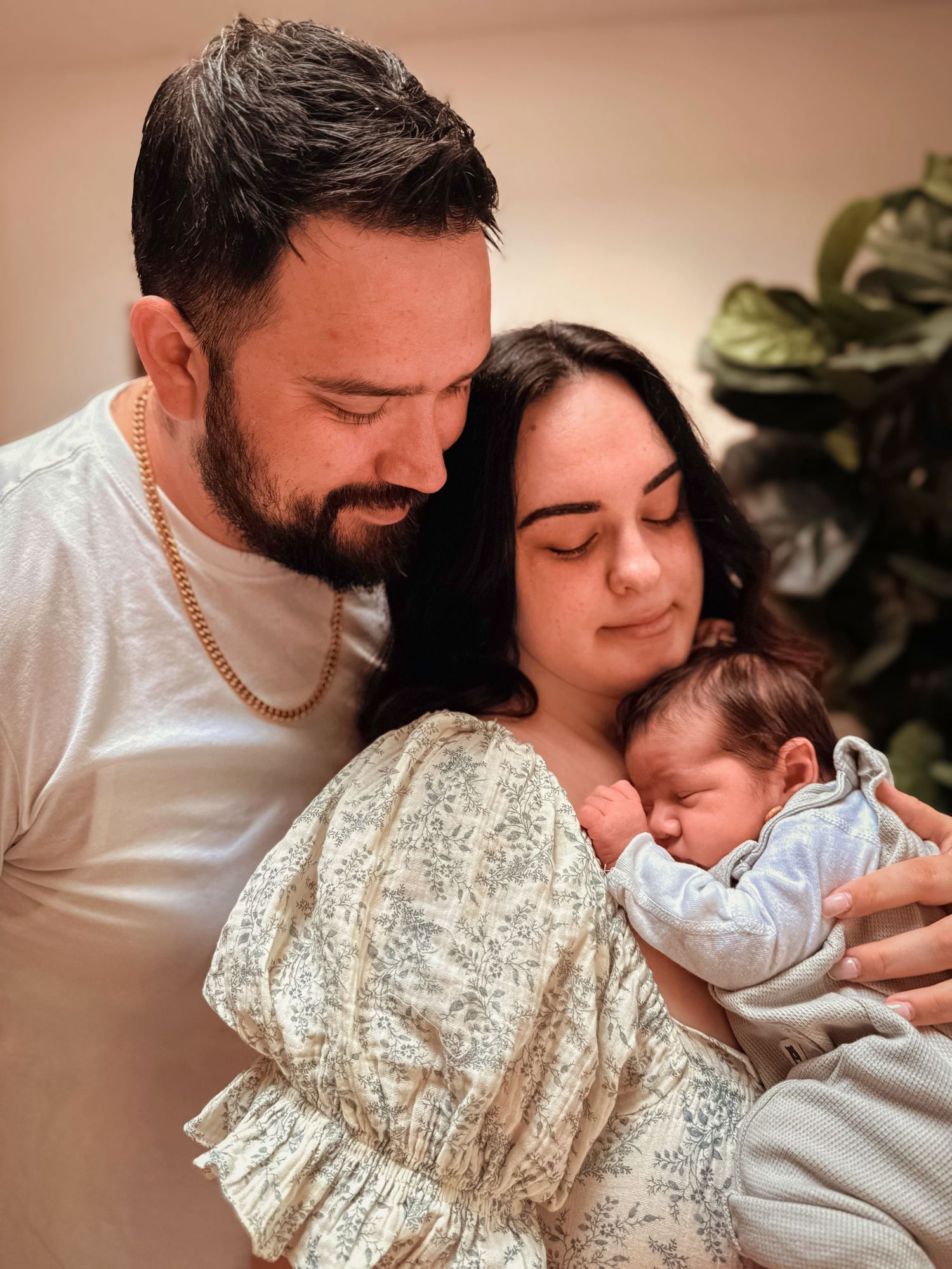 Mom and dad holding their newborn baby together during a Colorado Springs lifestyle newborn photography session.