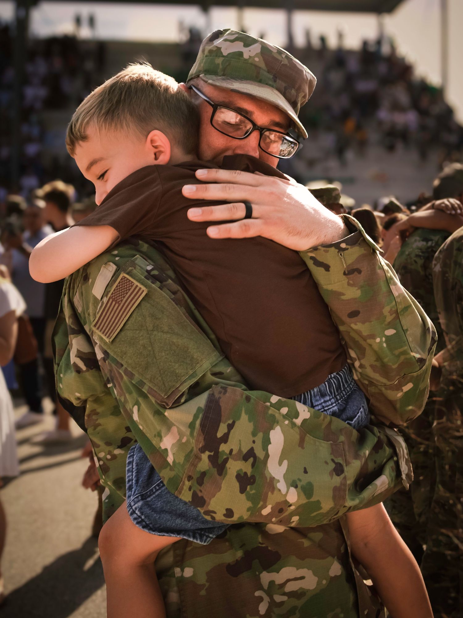 Airman hugging young son during a U.S. Air Force Academy graduation family photography session in Colorado Springs.