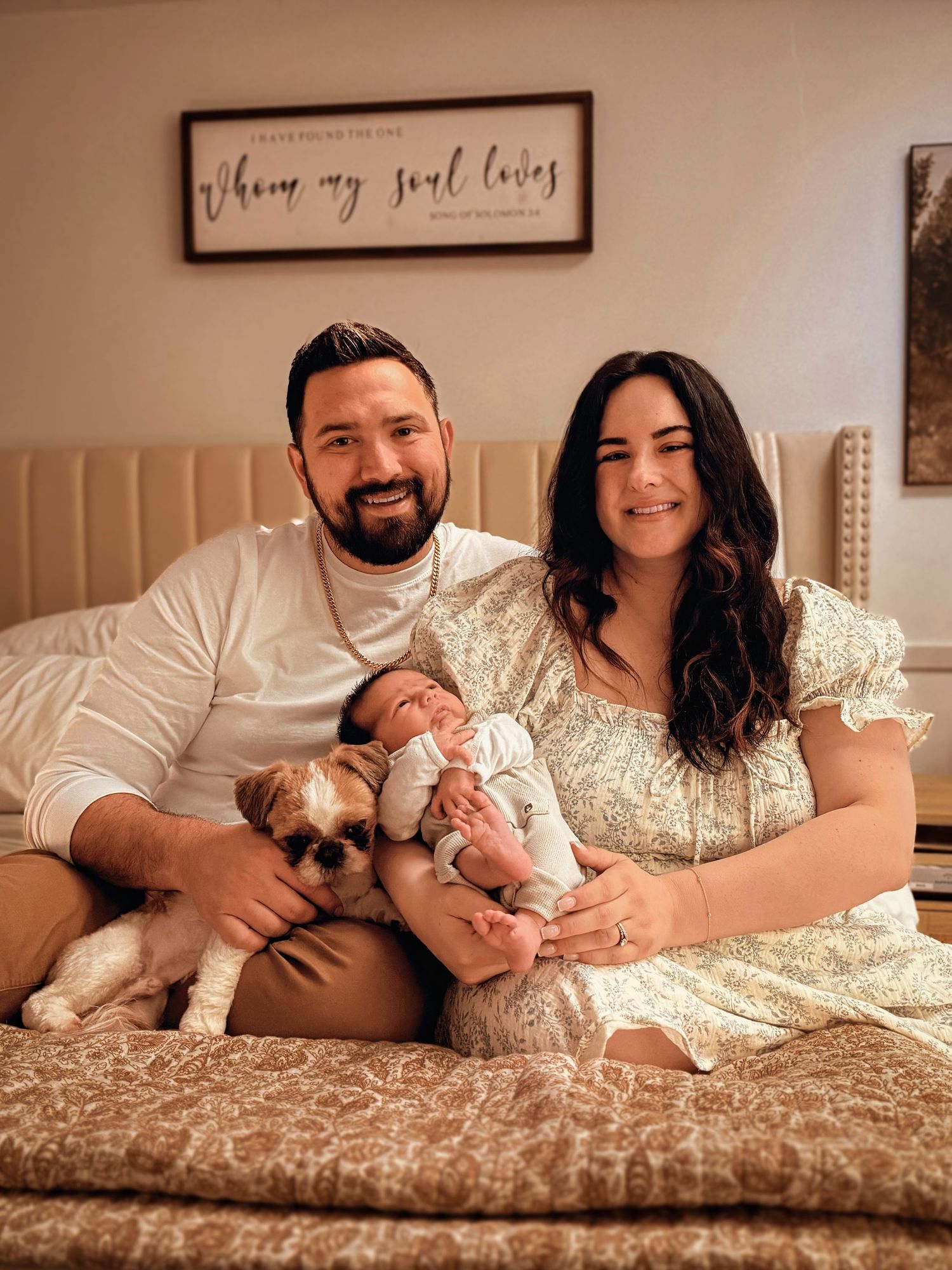 Parents sitting together with their newborn baby during a relaxed at-home family and newborn photography session in Colorado Springs.