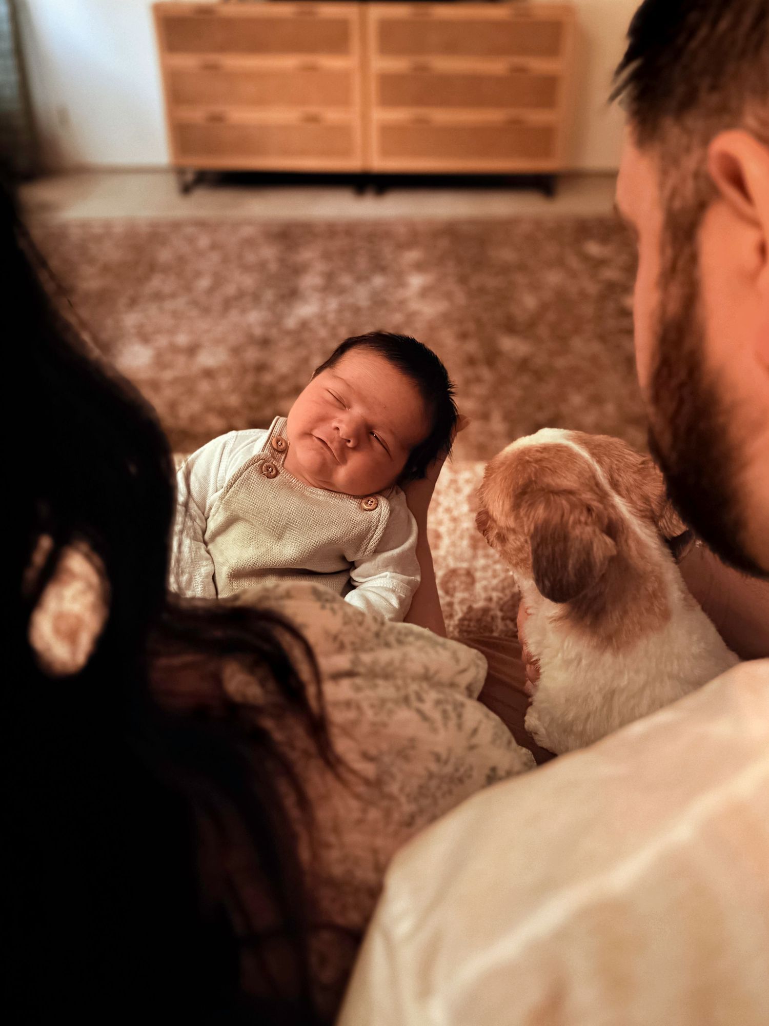 Candid lifestyle photo of parents spending time with their newborn baby during an at-home newborn session.