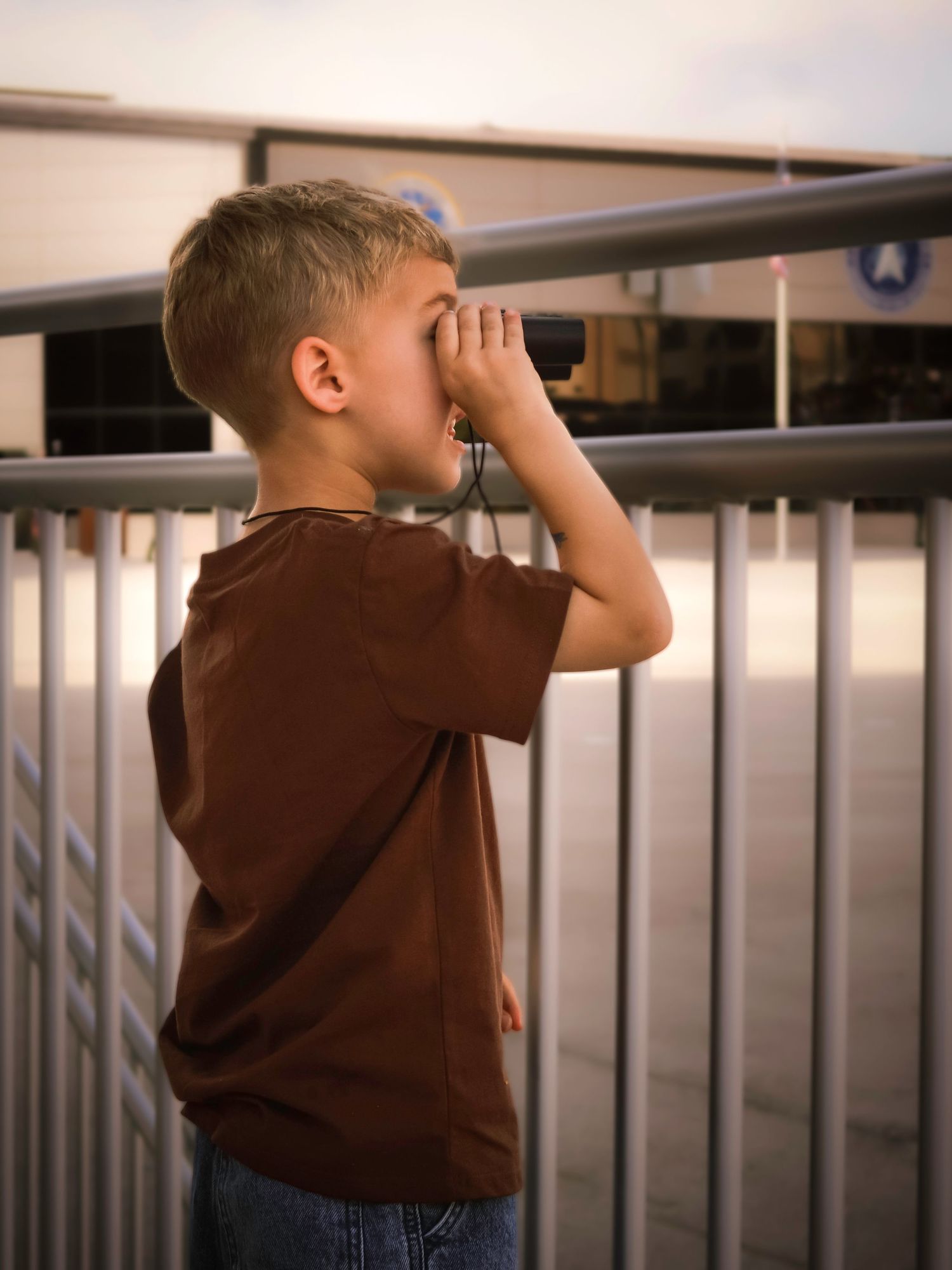 Young son watching an Air Force graduation ceremony during a military family photography session in Colorado Springs.