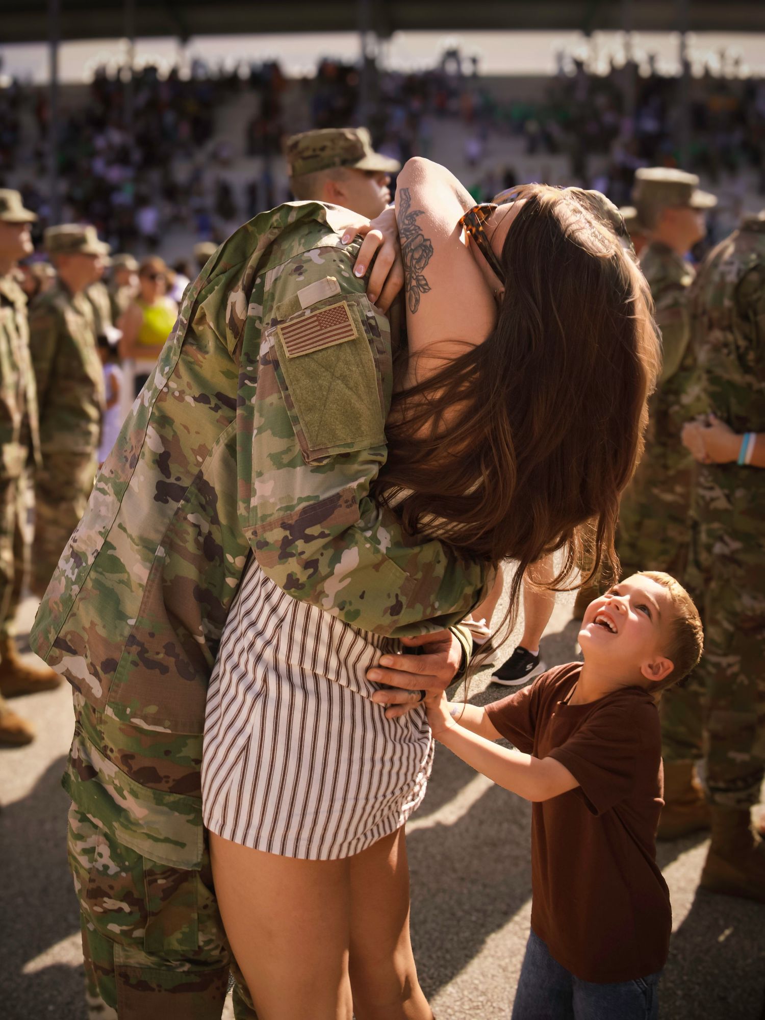Air Force graduate embracing family during a military graduation celebration at the U.S Air Force Academy in Colorado Springs.