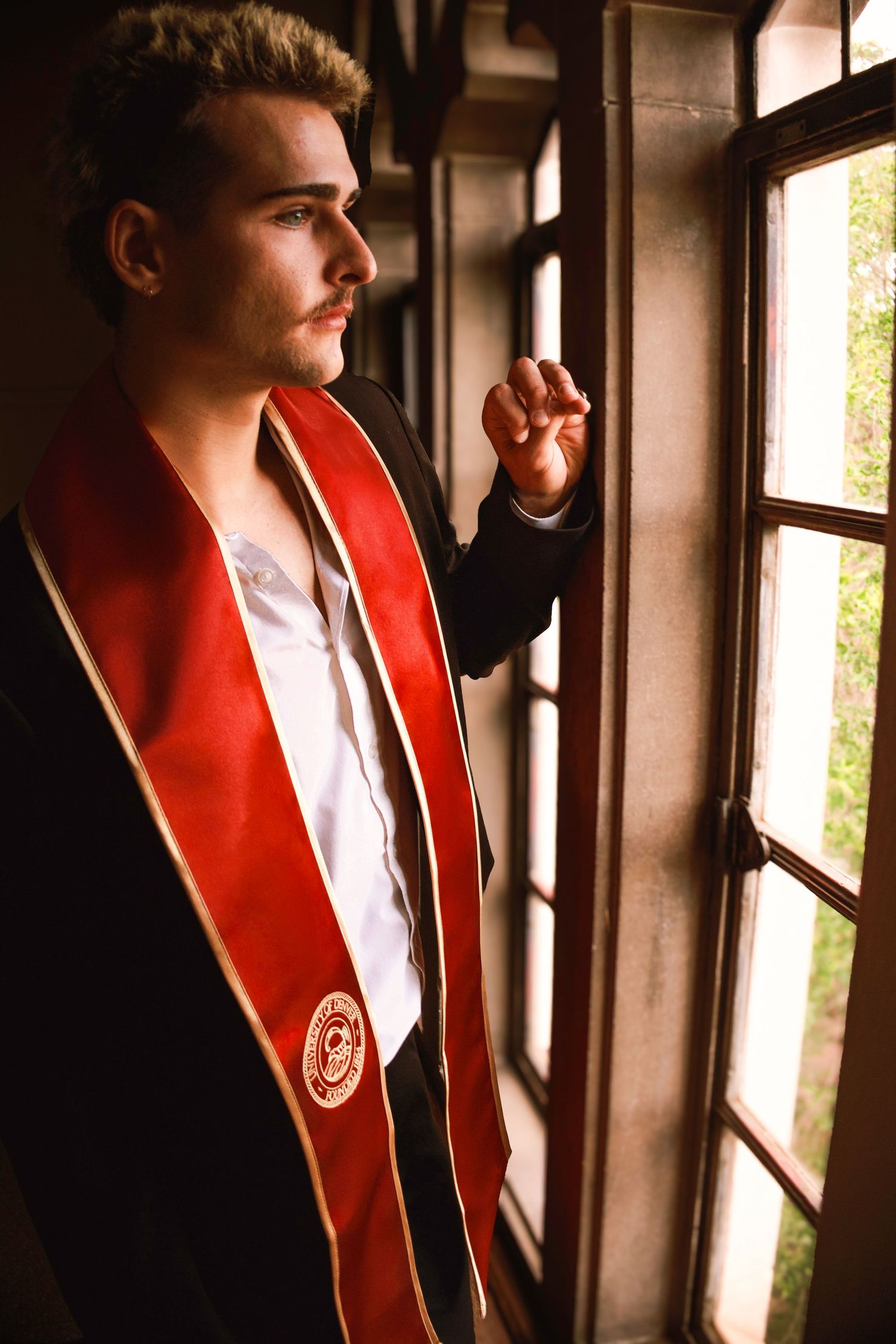 Urban graduation portrait
Colorado Springs senior graduation portrait of a male graduate posing against an urban wall in his graduation