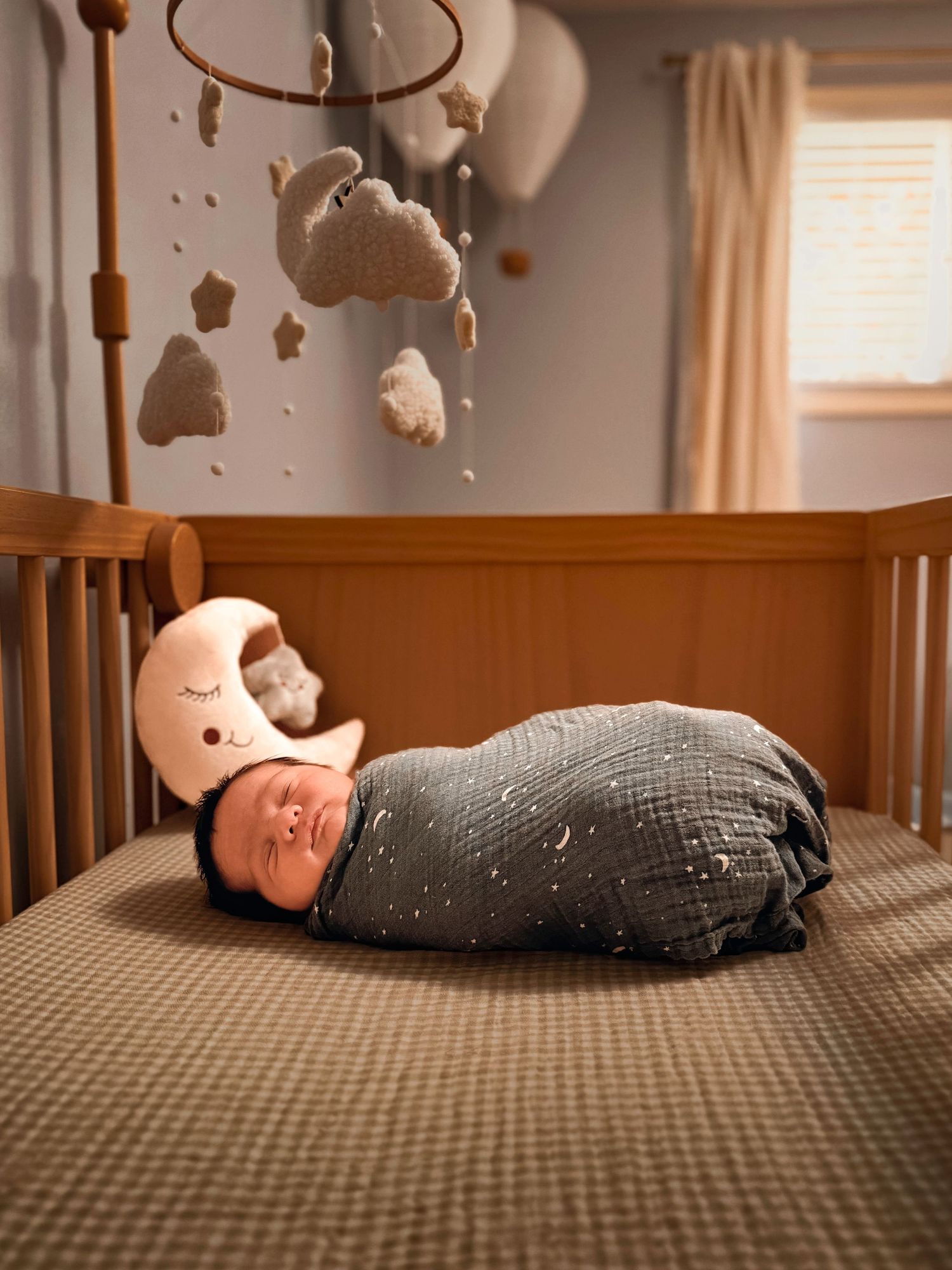 Newborn baby resting peacefully on a chair during a lifestyle newborn photography session at home in Colorado Springs.