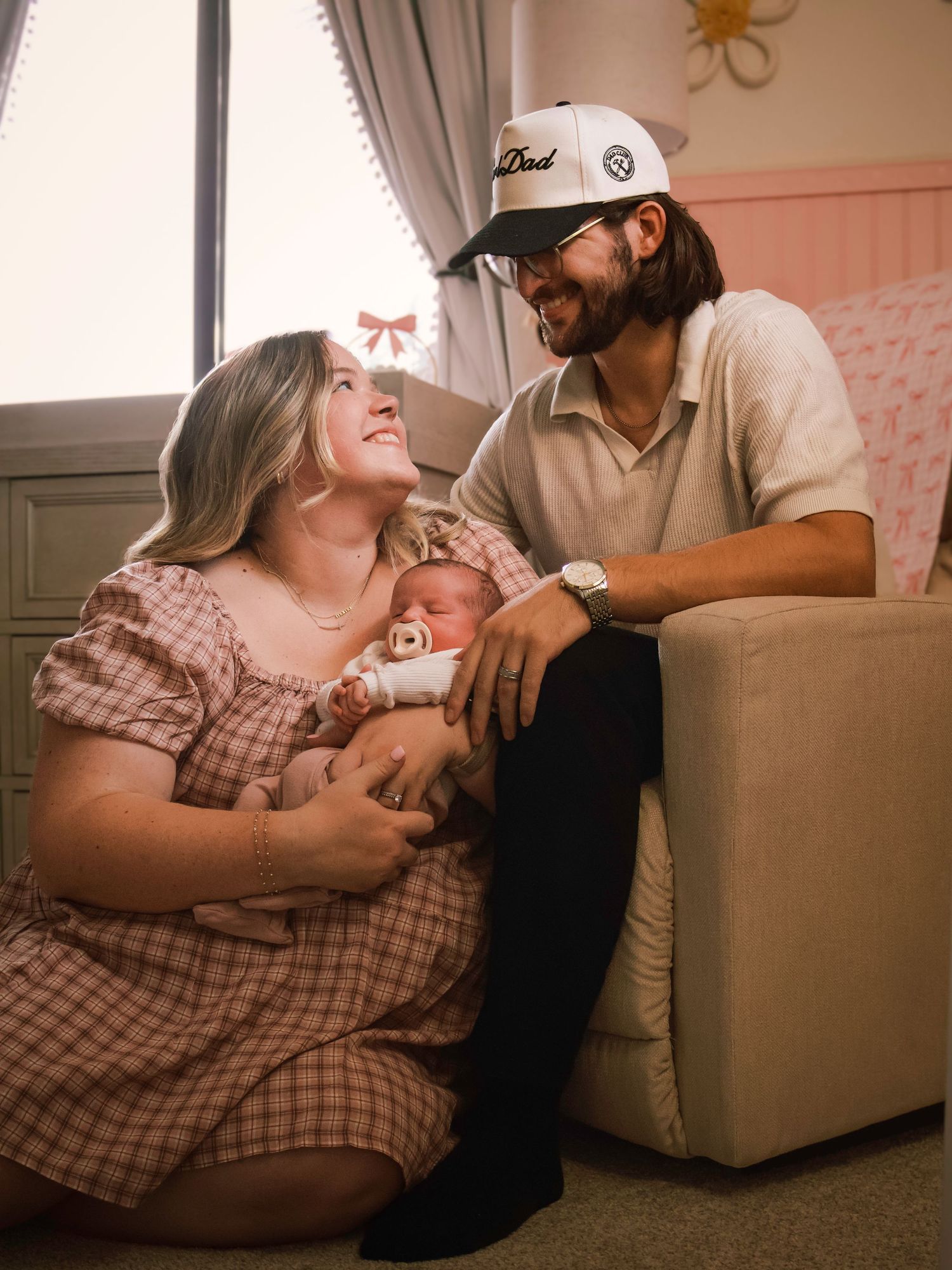 New parents sharing a tender moment with their newborn baby during a relaxed in-hime family photography session in Colorado Springs.