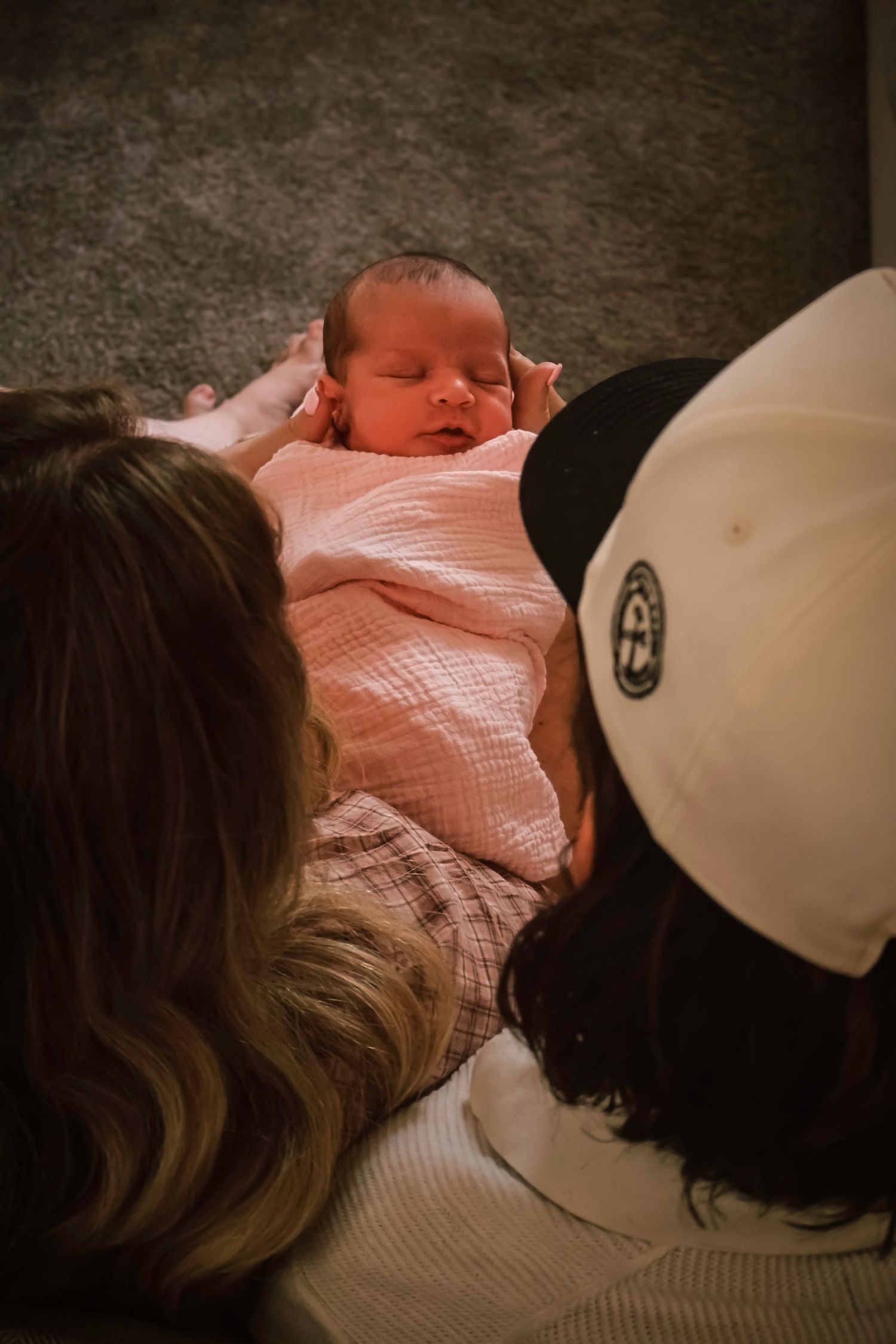 Parents sharing a quiet moment with their newborn baby during an intimate in-home newborn photography session in Colorado Springs.