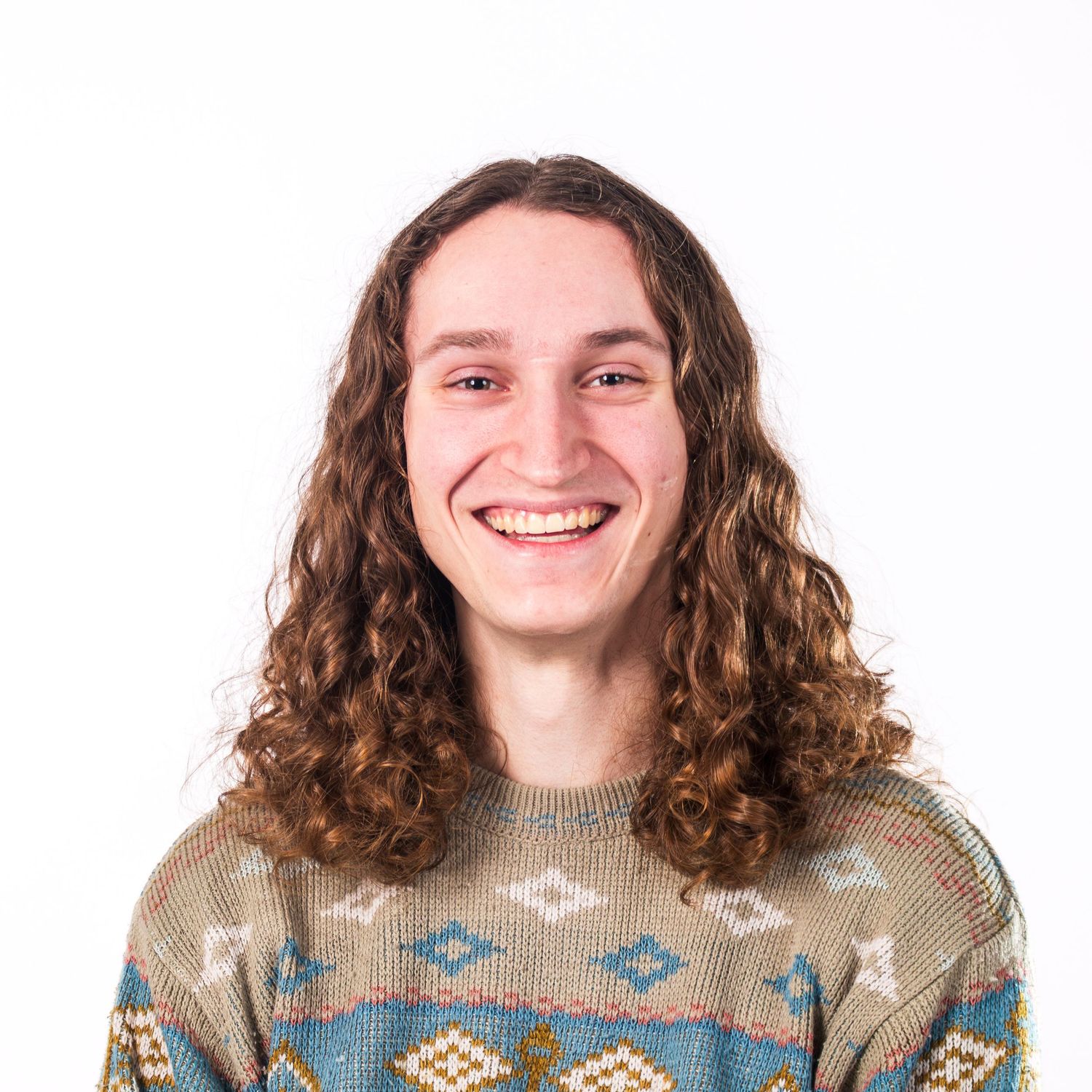 Collage of someone with curly brown hair wearing a patterned sweater showing different expressions and poses.