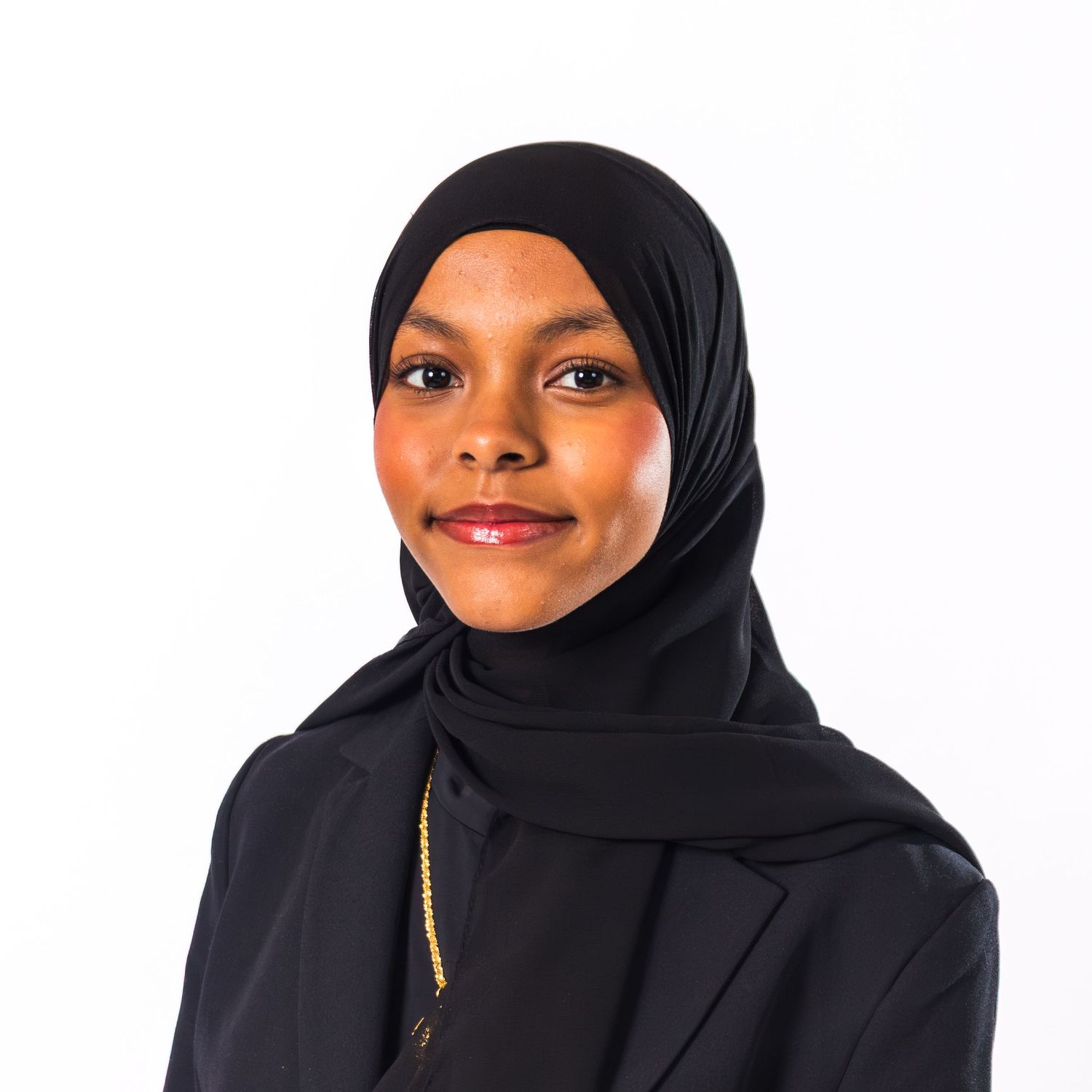 Woman wearing black hijab and dark blazer shown in four different poses against white background.