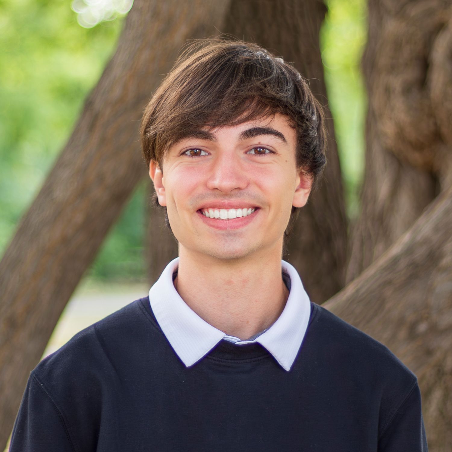 High school senior outdoor portrait session showing graduate in formal attire with natural background.