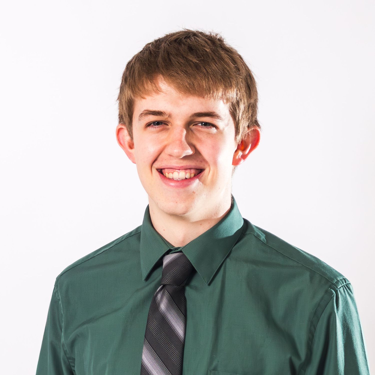 Smiling person in a green dress shirt and black tie against white background in a series of four similar poses.
