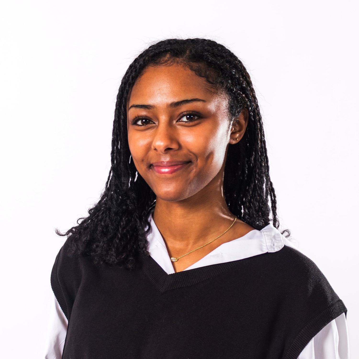 Professional headshot portraits of someone in a black blazer and white top against a light background.