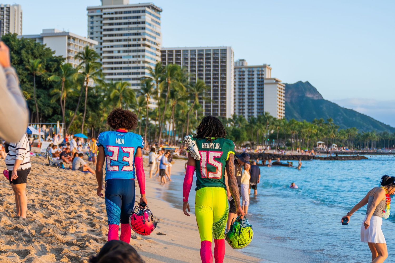 Waikiki Beach panorama with high-rise hotels, palm trees, and beachgoers enjoying the blue ocean waters.