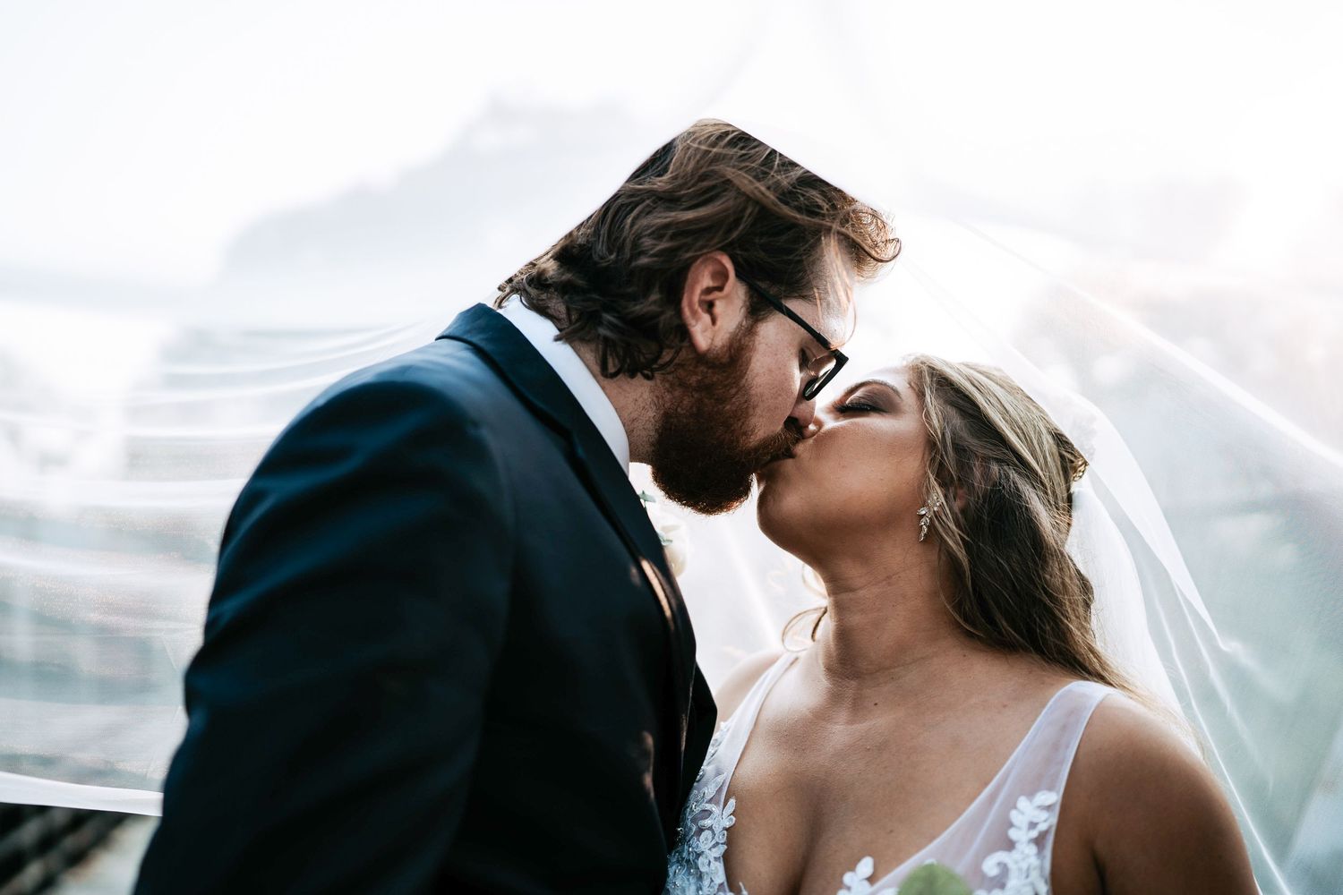 Romantic veil kiss close-up of bride and groom during Michigan wedding by Bylitos Studio Michigan