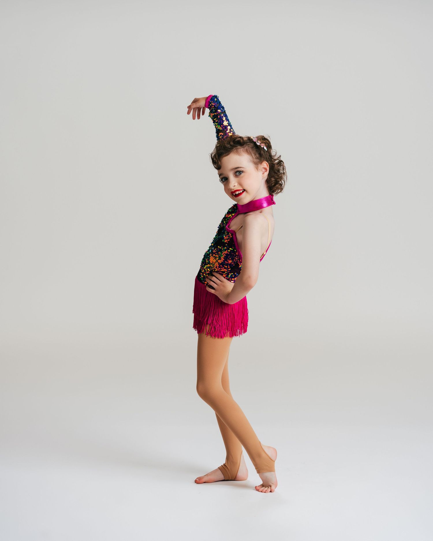 Young dancer in magenta sequin costume posing in studio editorial session by Bylitos Studio Michigan