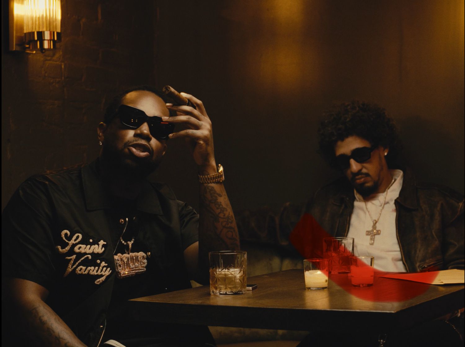 Two men at a table in moody restaurant setting during cinematic lifestyle shoot by Bylitos Studio Michigan