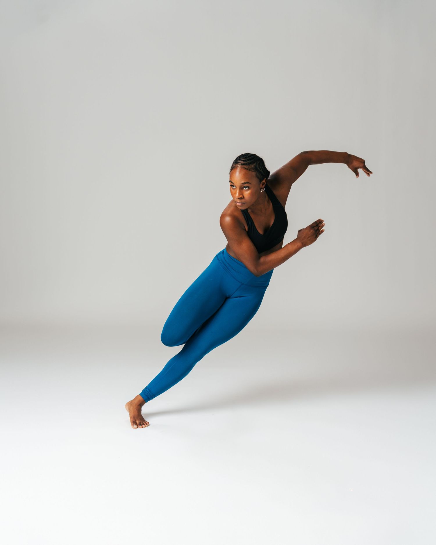 Dancer in royal blue outfit mid-lunge during dance editorial session by Bylitos Studio Michigan