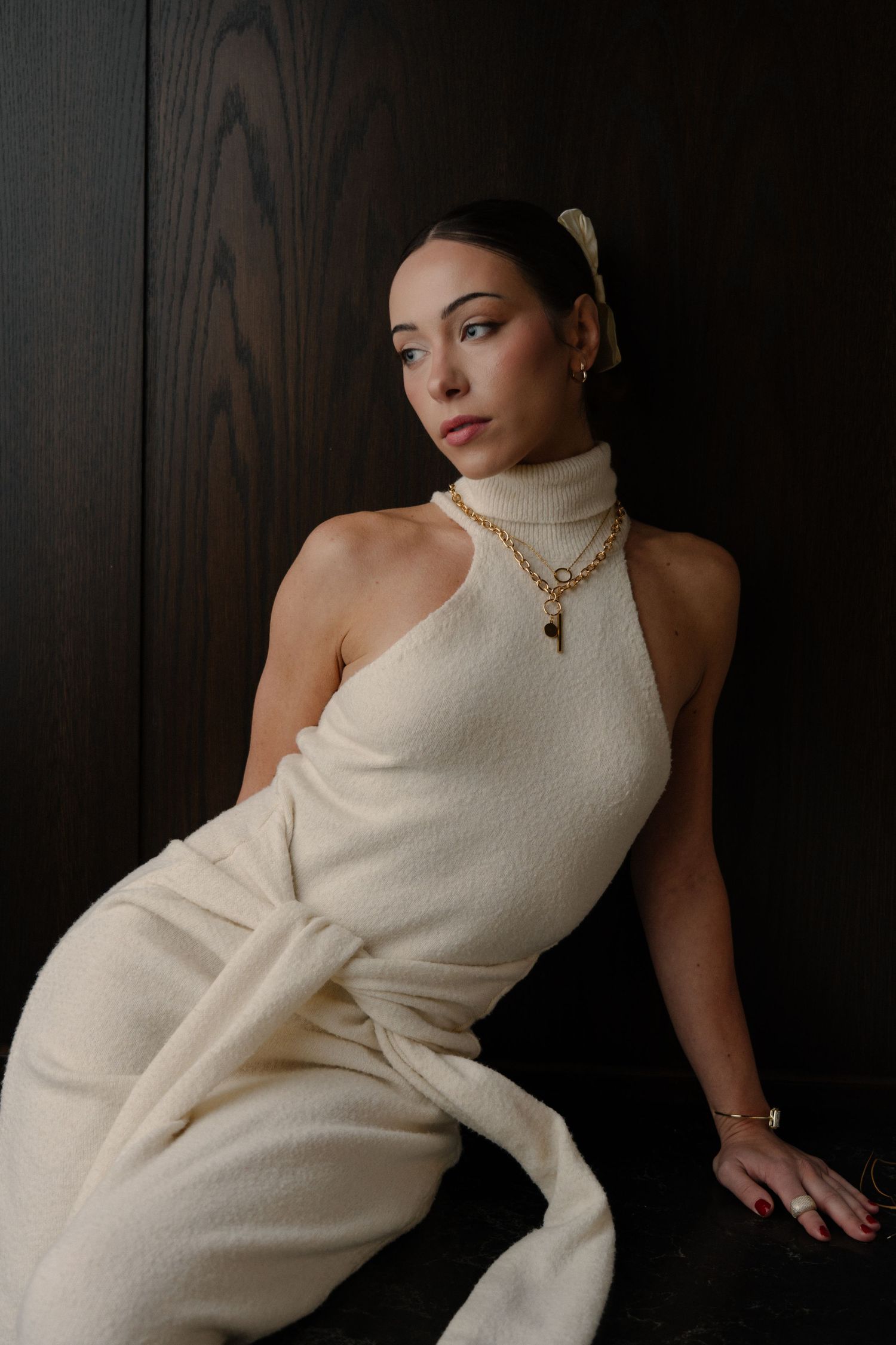Close-up lifestyle portrait of woman lying down showcasing gold rings and jewelry by Bylitos Studio Michigan