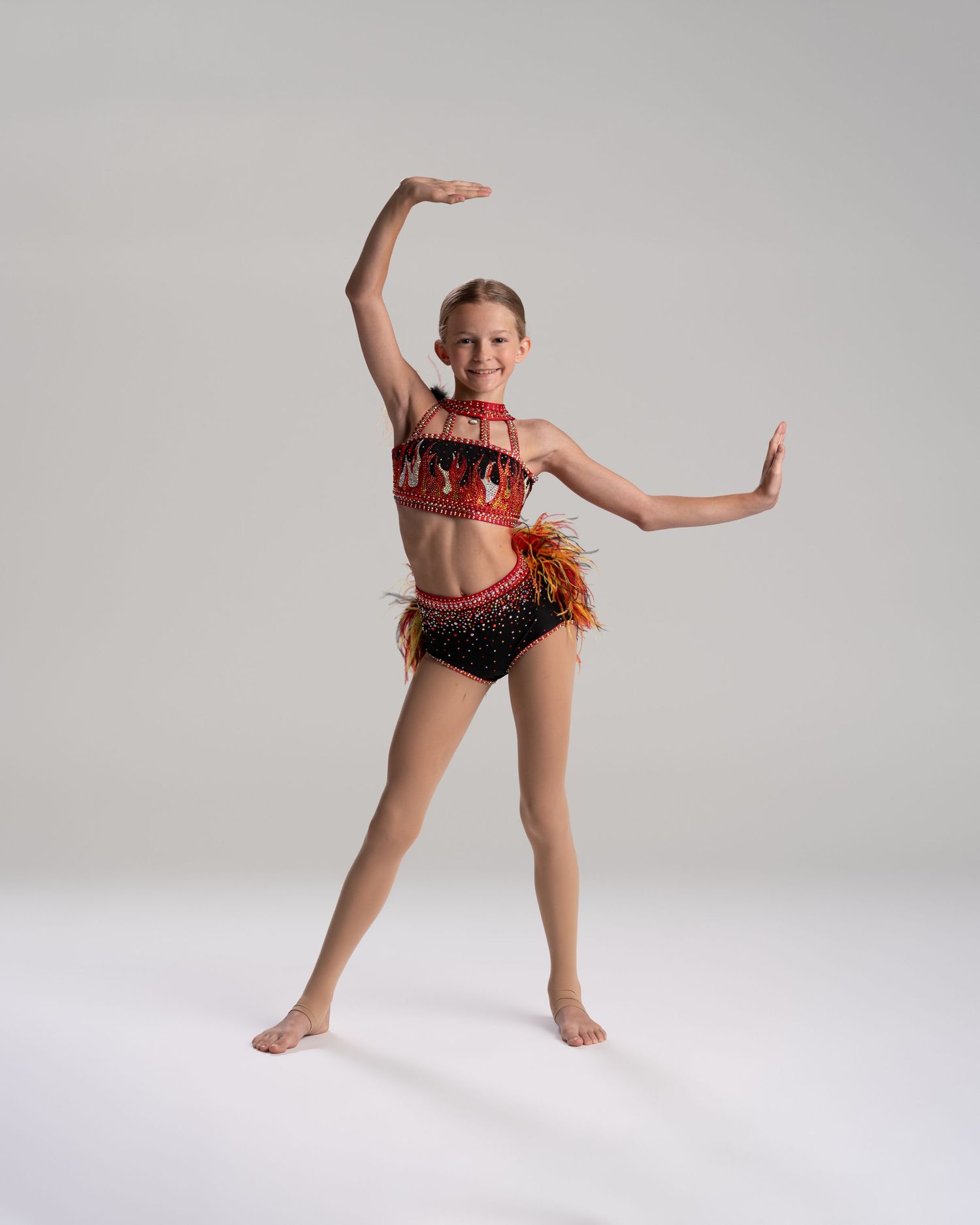 Adult dancer lifting young dancer overhead in studio dance editorial by Bylitos Studio Michigan