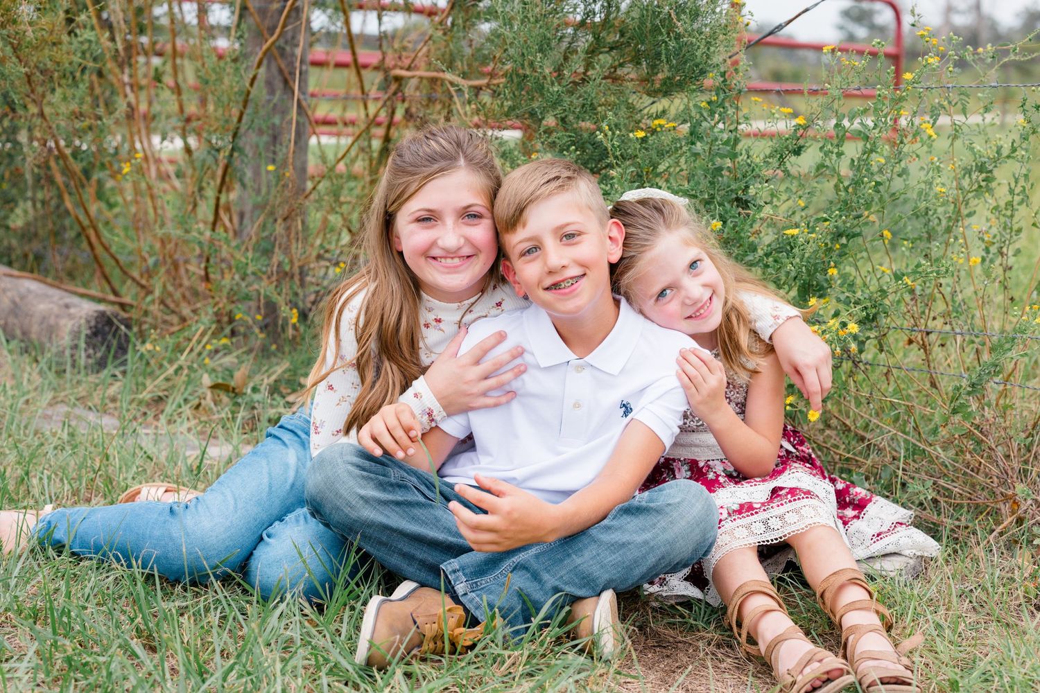 Casual outdoor family photoshoot among green foliage and natural scenery.