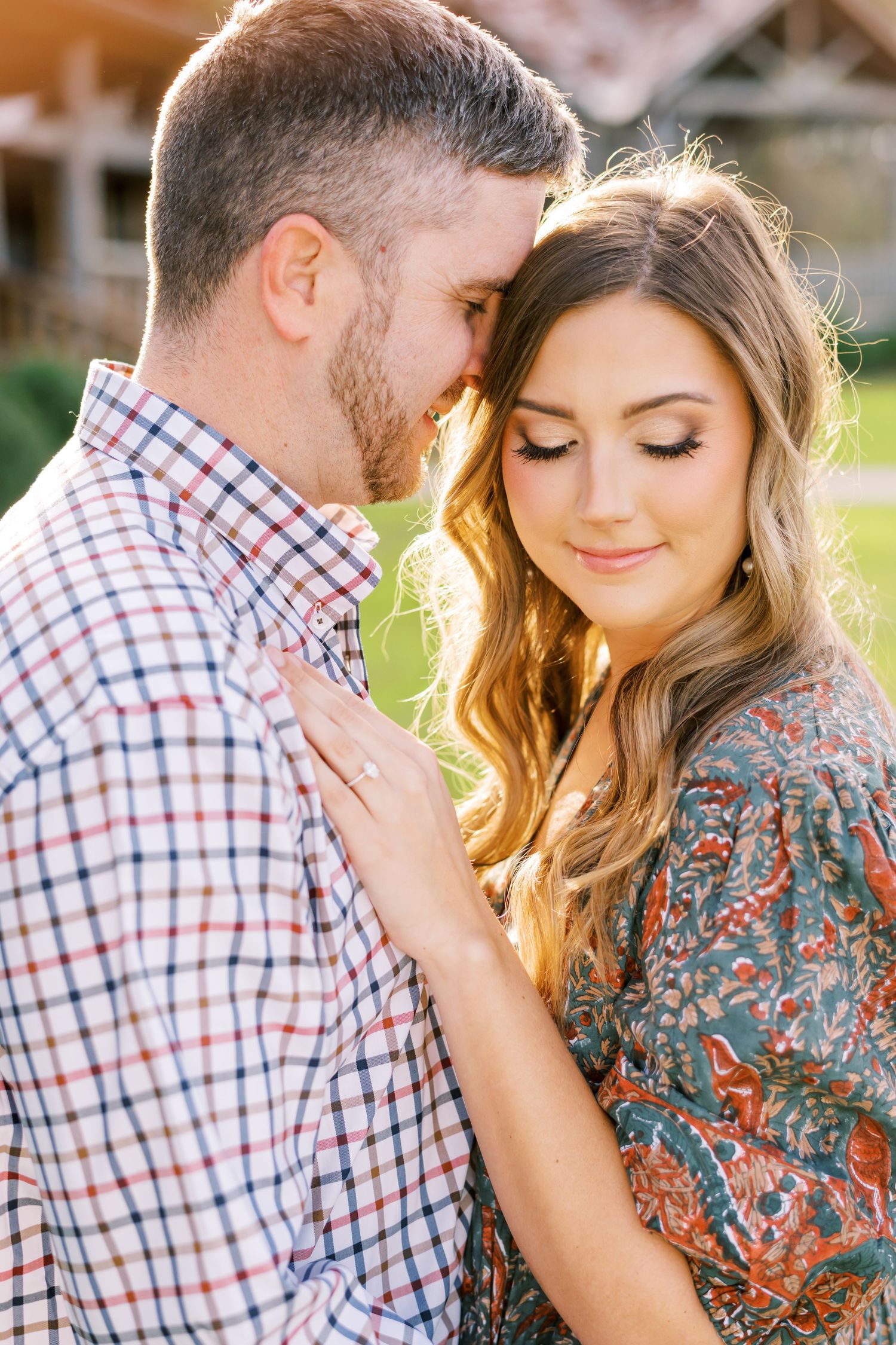Romantic couple portrait session in warm sunlight with soft intimate poses.