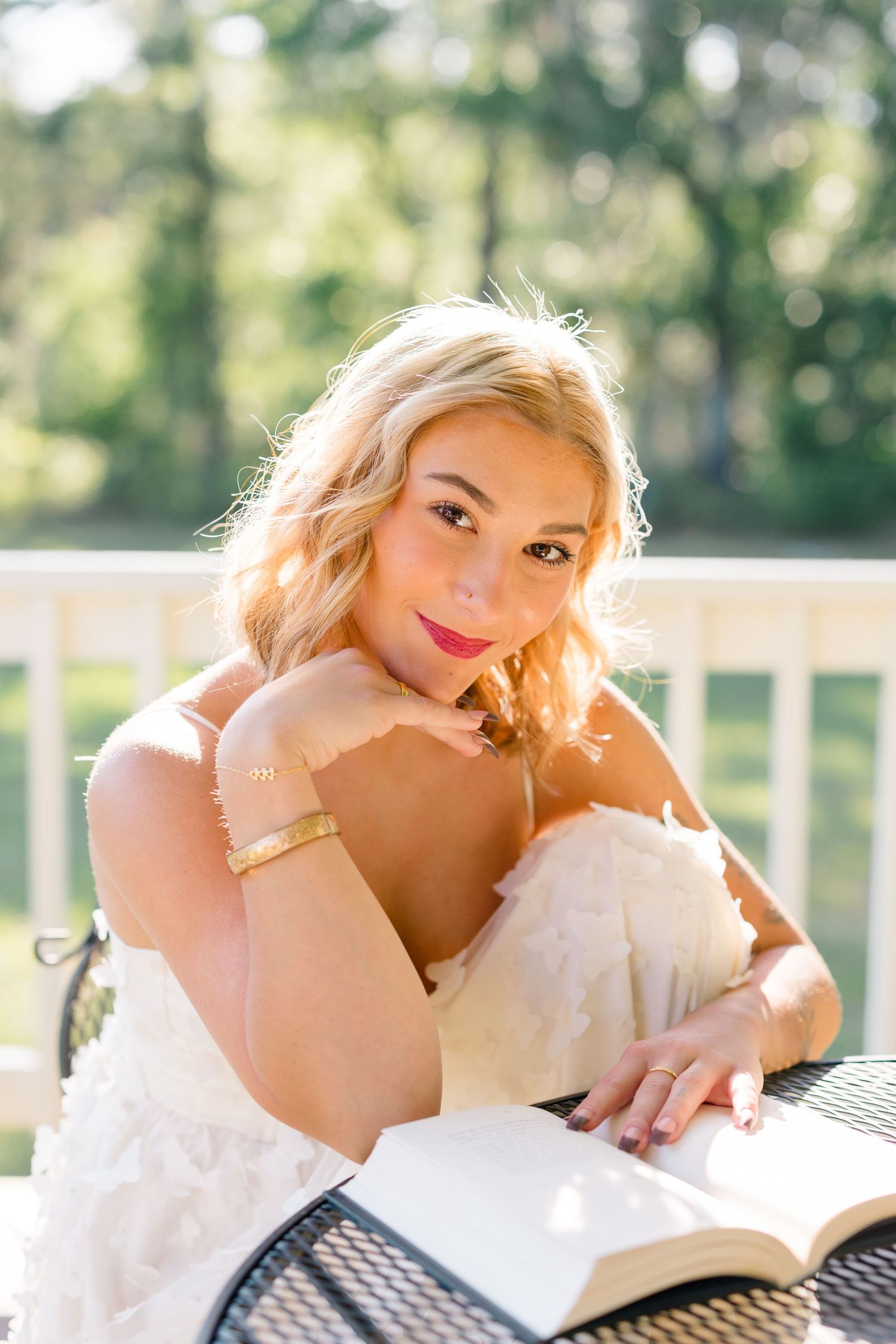 Dreamy outdoor portrait session on white porch with soft natural lighting.
