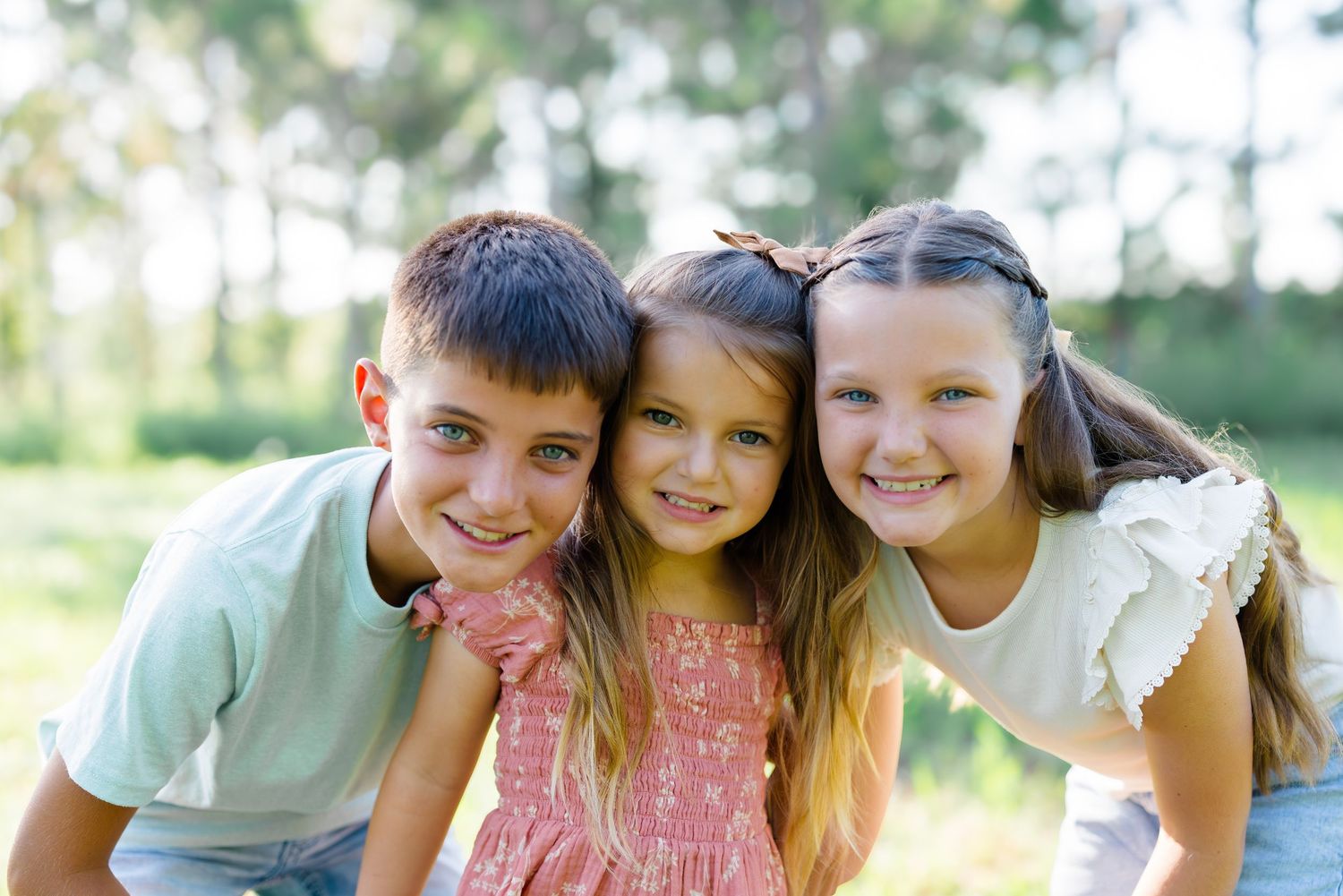 Candid moments of family togetherness captured in a series of outdoor portraits.