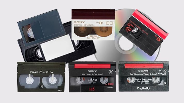 A collection of old VHS video tapes stacked together showing their spines and labels.