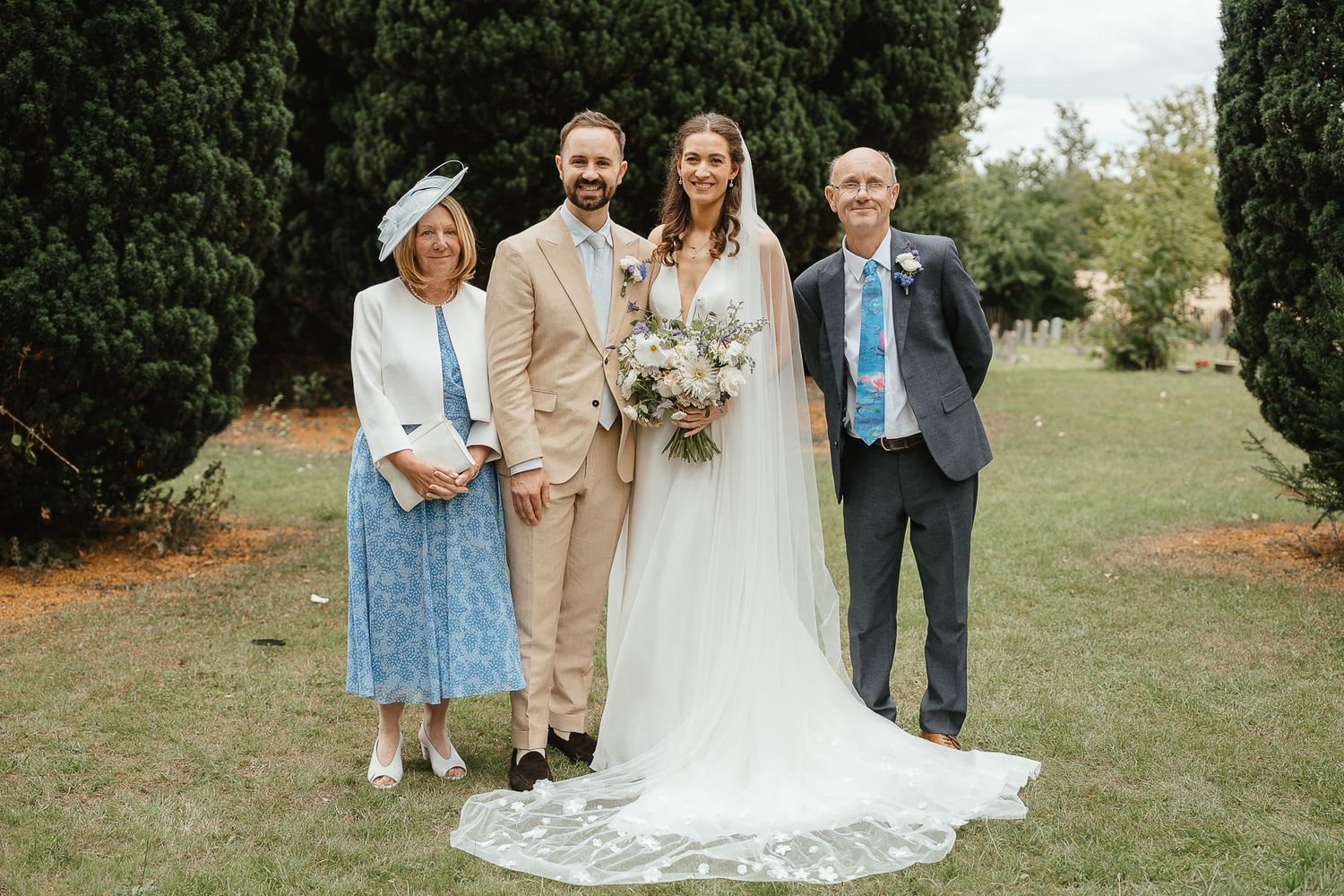 Outdoor wedding ceremony snapshots showing people in formal attire gathered on a grassy lawn at sunset.