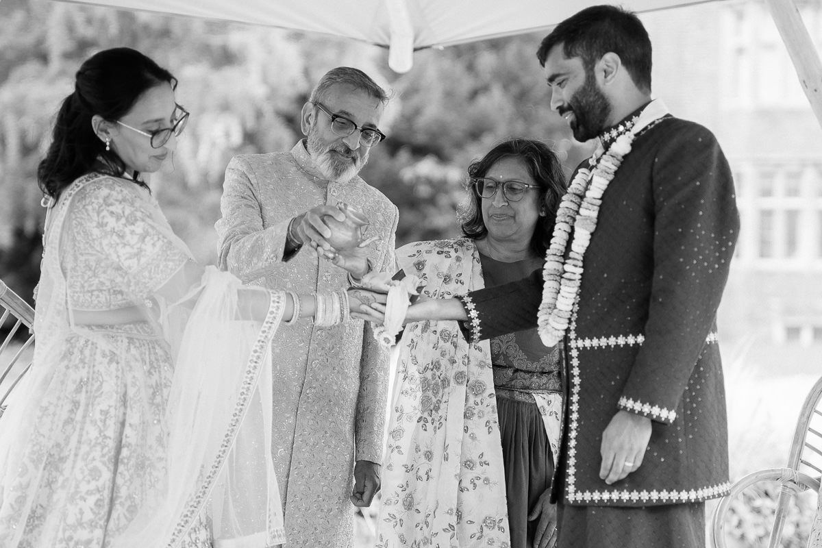 A series of black and white wedding photographs showing intimate moments between couples during an outdoor ceremony.