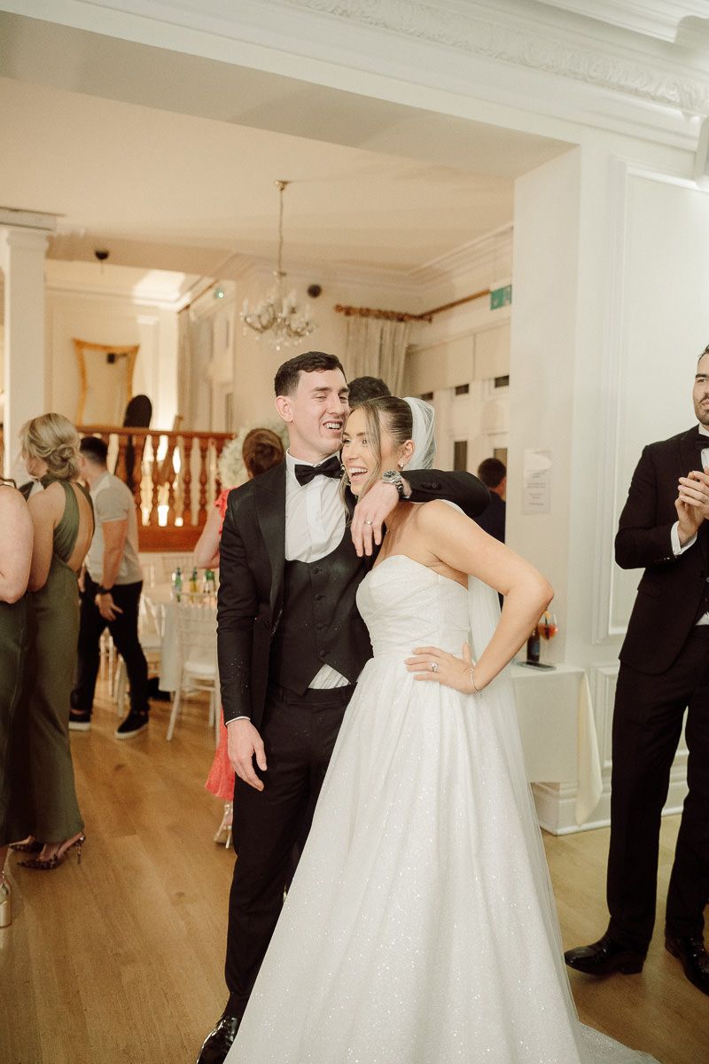 A series of four wedding photos showing a couple's first dance in a bright indoor venue with wooden floors.
