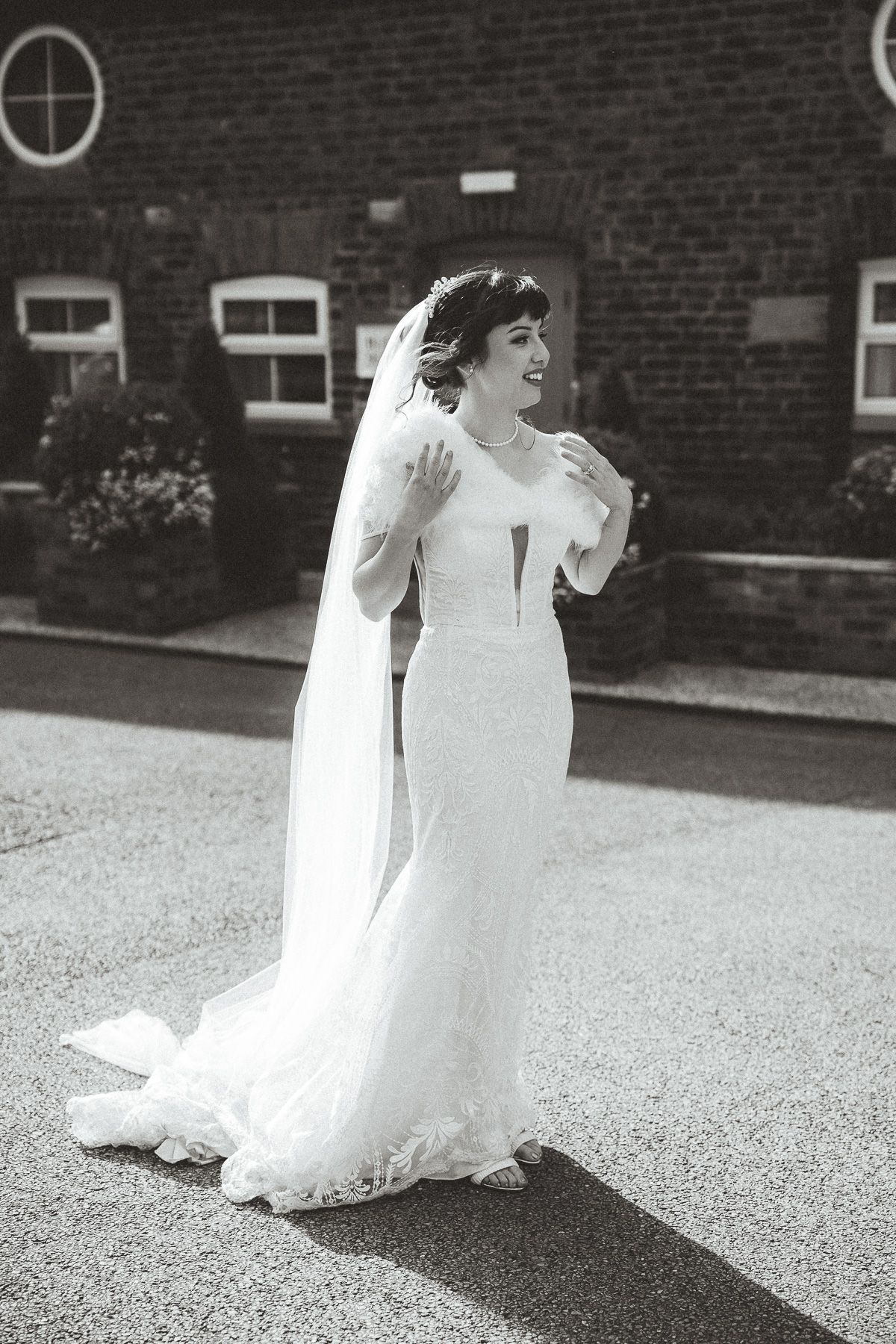 Five black and white photos show a flowing white wedding dress elegantly sweeping across a paved outdoor surface.