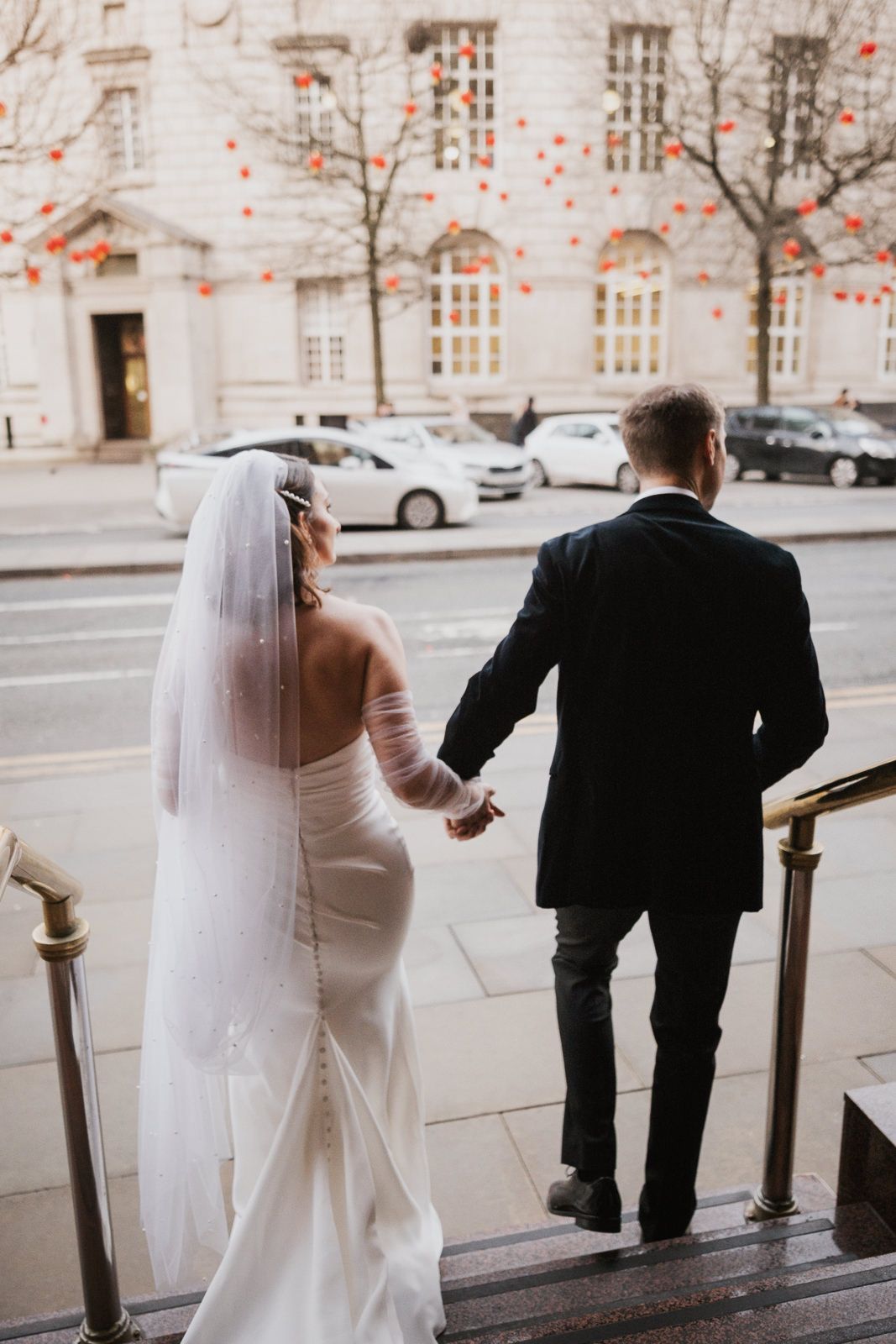 A sequence of wedding photos showing a bride in white gown and groom in black suit ascending outdoor stone steps.
