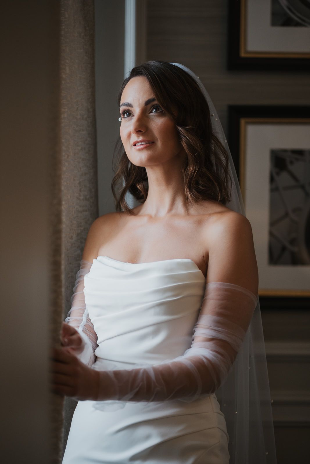 A series of elegant bridal portraits showing a figure in a classic white off-shoulder wedding dress against a soft interior backdrop.