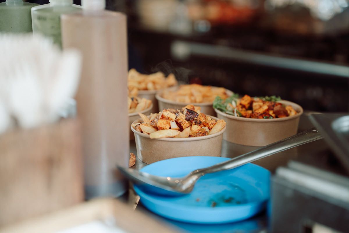 Close-up view of catered food dishes displayed on a buffet table at an event.