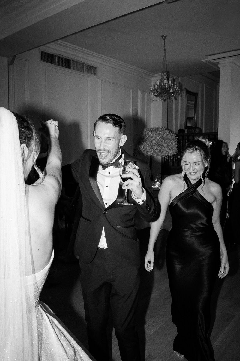 Black and white photos show people in formal attire dancing and mingling at an elegant party or reception.