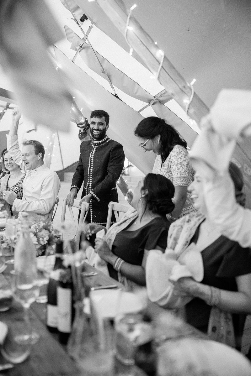 A black and white photo sequence showing people laughing and celebrating at a social gathering.