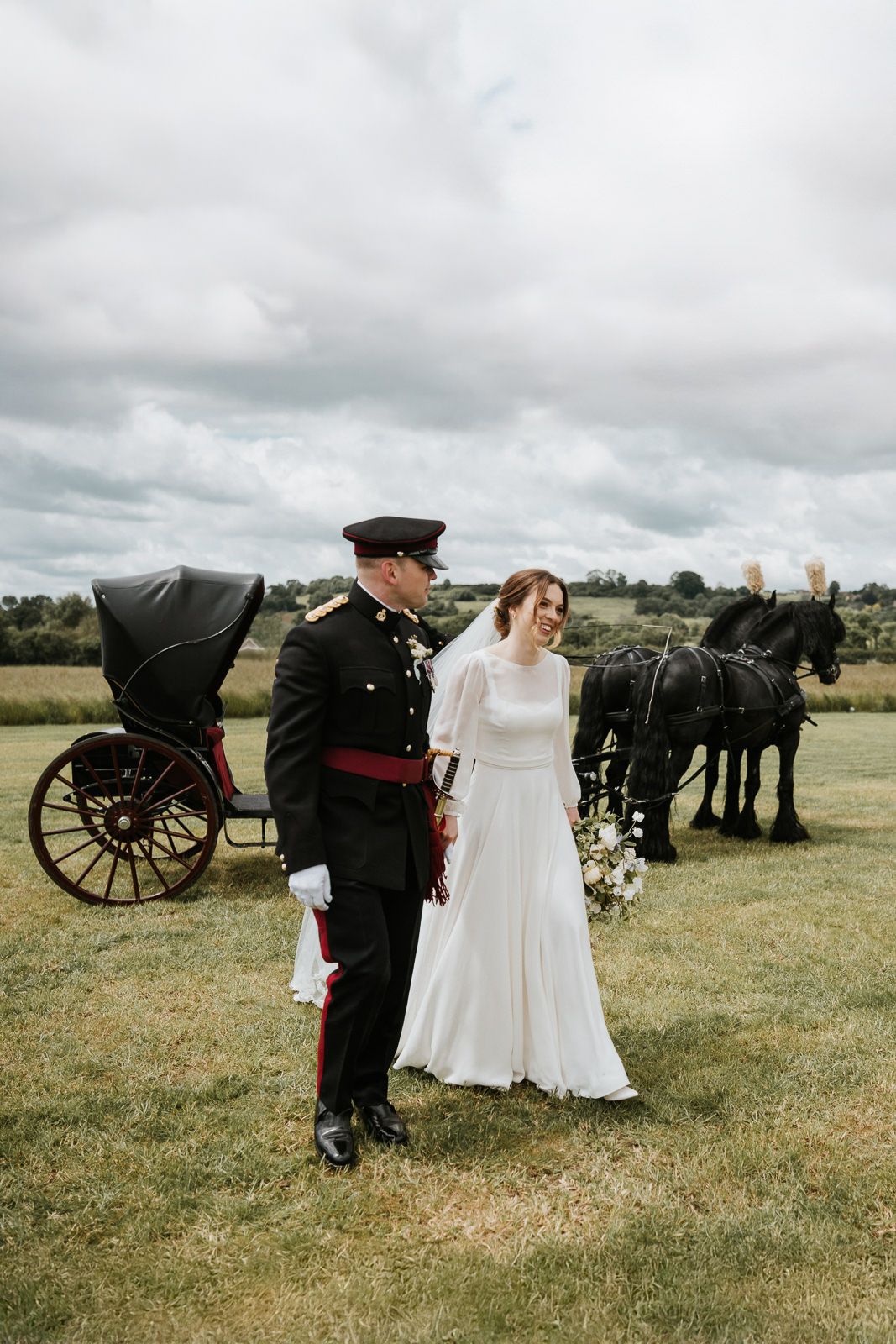 A romantic vintage-style wedding scene with a horse-drawn carriage in a pastoral countryside setting.