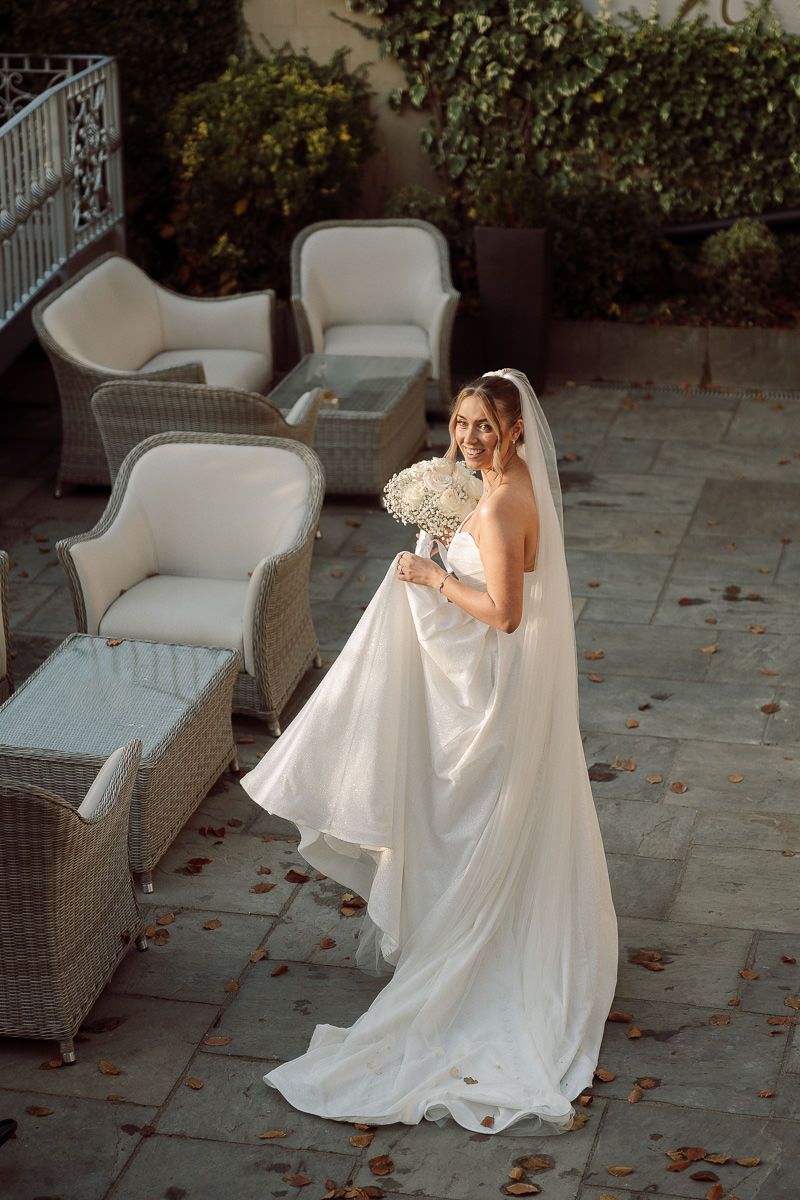A series of photos showing a bride in a flowing white gown sitting on outdoor patio furniture at dusk.
